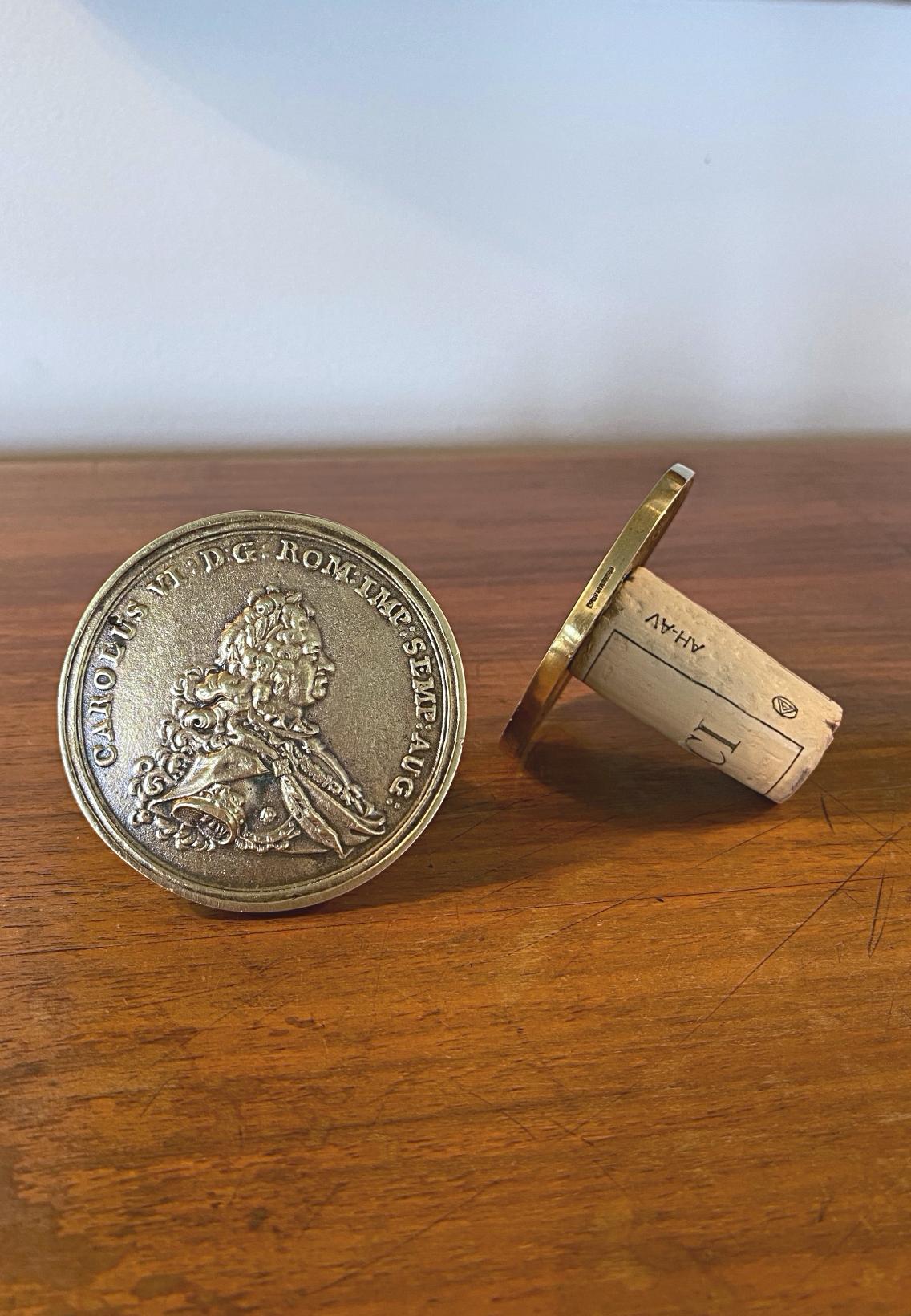 Pair of beautiful large Auböck coin bottle stoppers in solid brass, made by Werkstätten Carl Auböck in 1950s. The casting is very fine because these are the earlier stoppers. The stoppers are a copy of the famous Imperator Carolus VI coins.

We