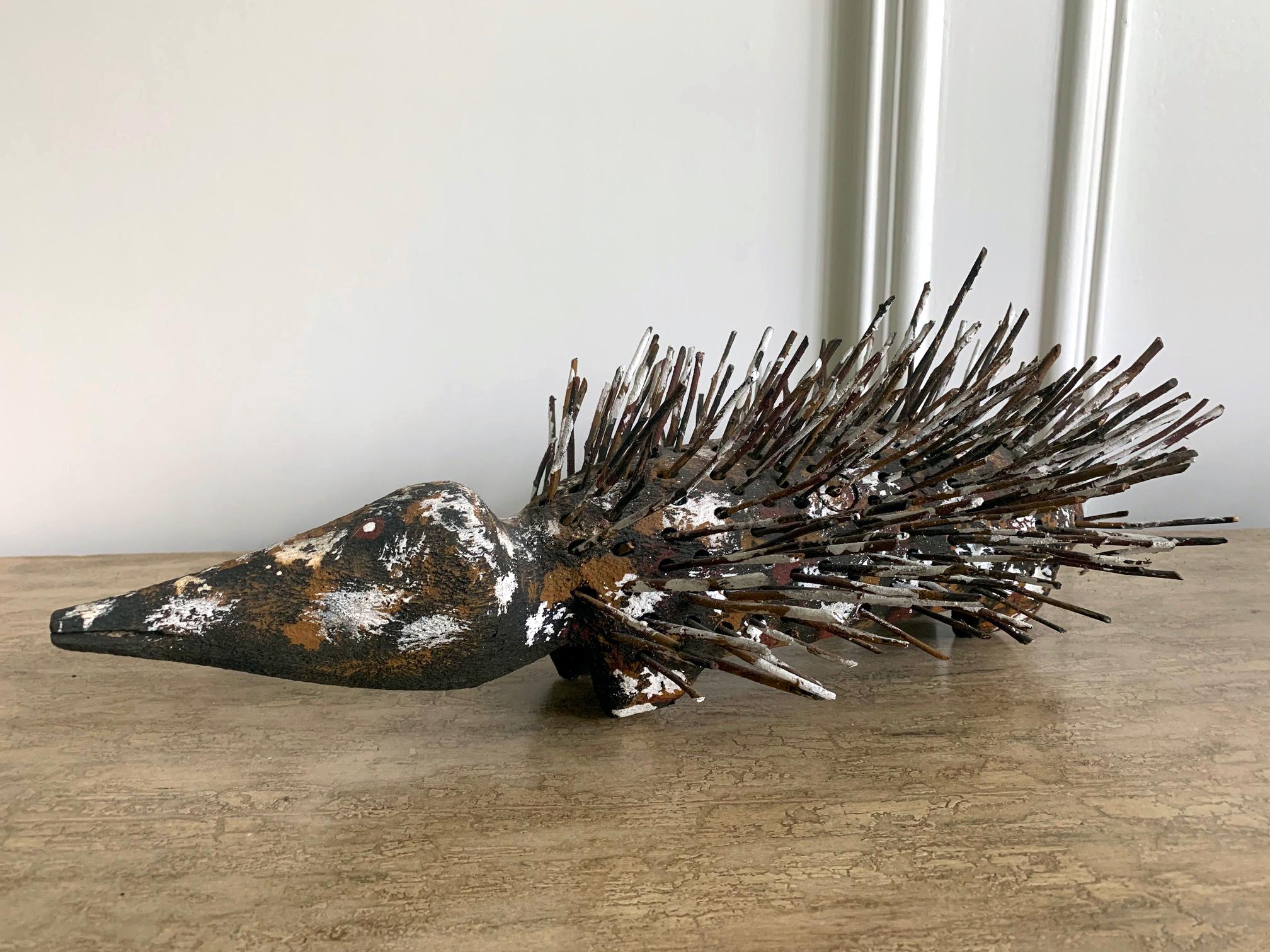 A pair of echidna sculpture carved from wood with found branches made by Australian Aboriginal artist Bob Burruwal (Born 1952-). Bob Burruwal is a celebrated Rembarrnga artist, who lives and works at Ankabarrbirri, an outstation, close to