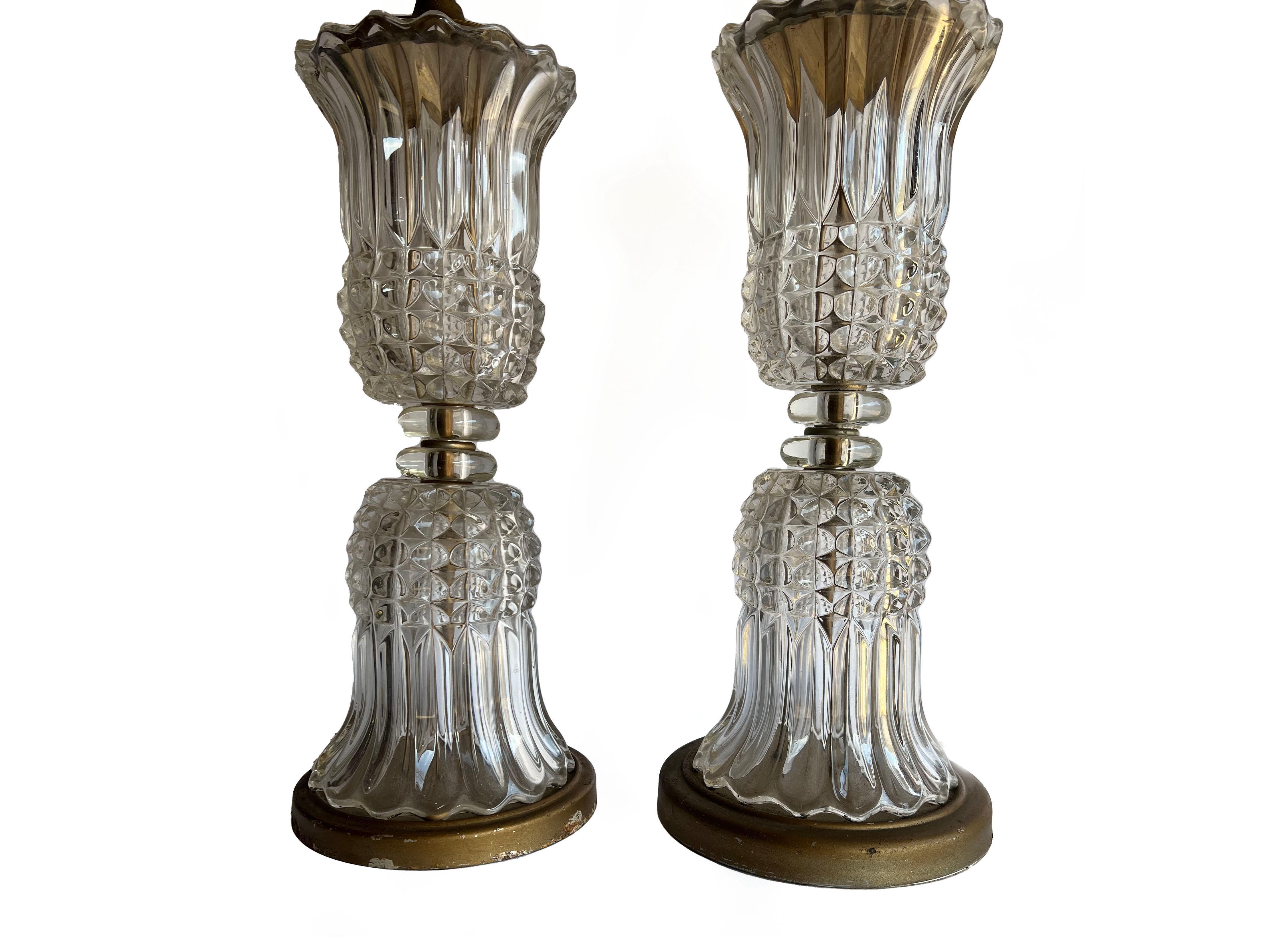 Pair of antique French Empire or Hollywood Regency style molded crystal glass lamps. Featuring a transparent, reflective, molded crystal vase form inverted on itself. Glass features diamond cut and fluting. Beautiful, sparkling addition to any