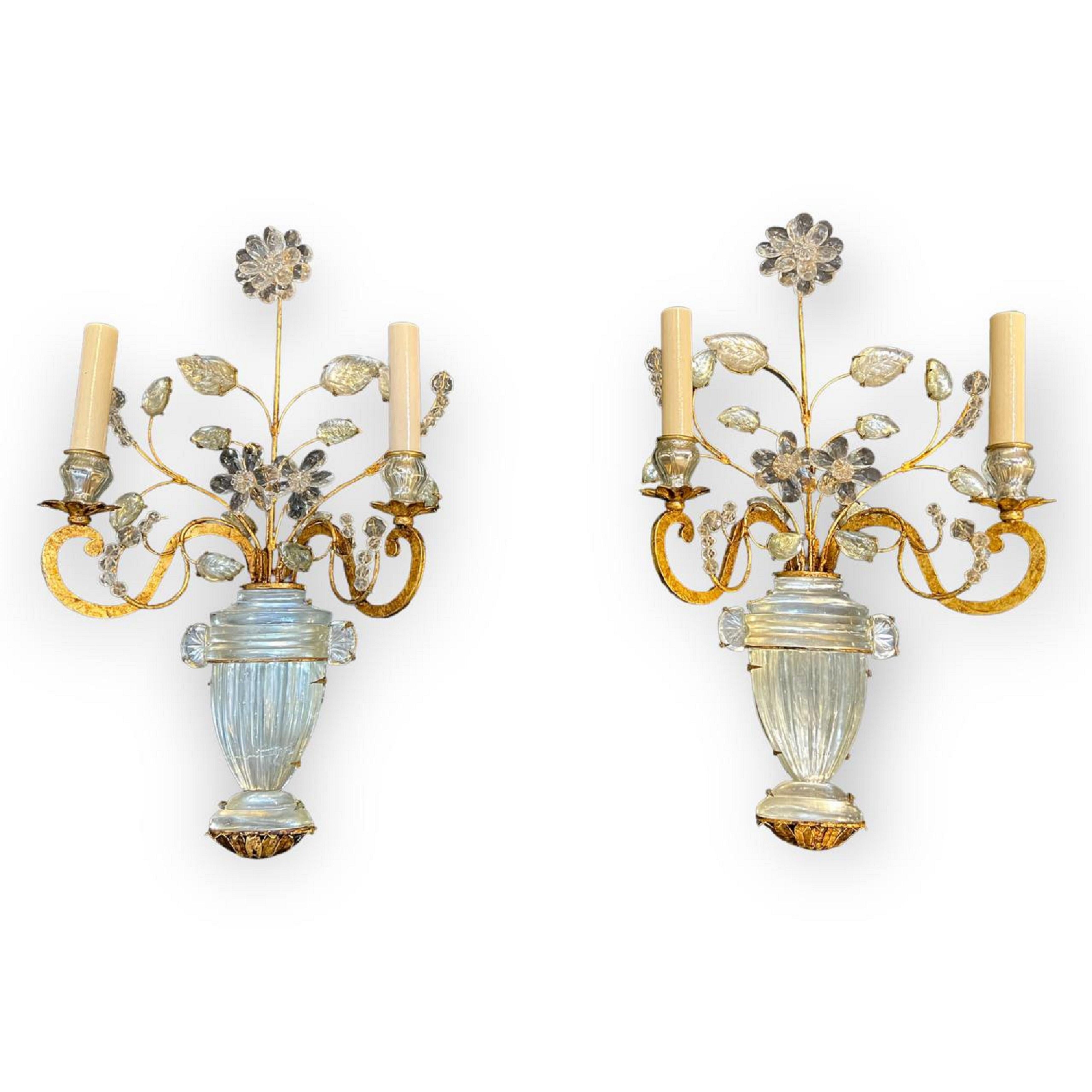A pair of circa 1940’s French Bagues crystal sconces with two lights and vase with flowers design. 3 pairs available -price per pair. In very good vintage condition. Lamp shade not included. 

Up to 120V (US Standard)
Hardwired

Dealer: G302YP 


