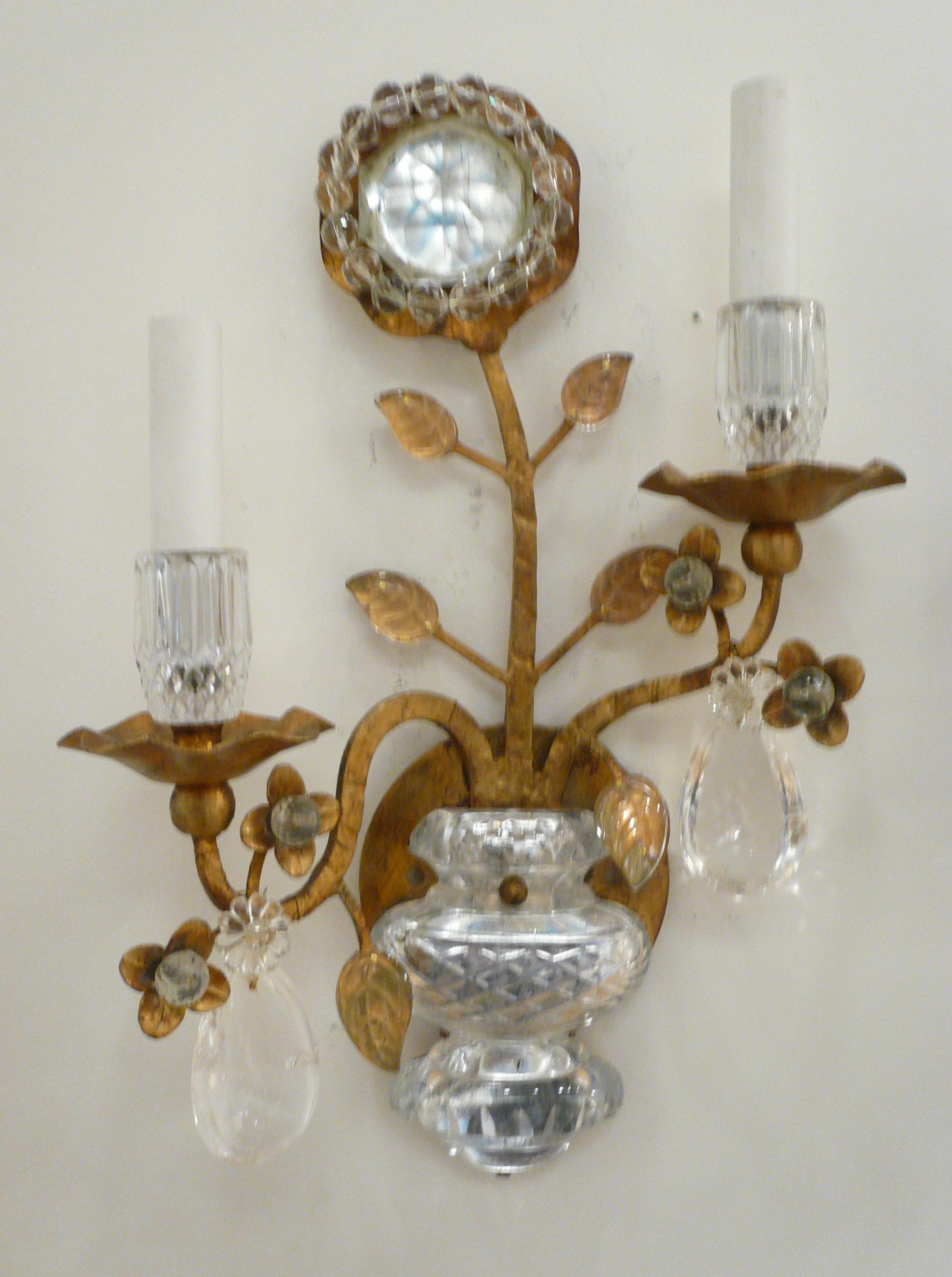 This pair of gilt wrought iron sconces feature crystal leaves and flowers, and rock crystal drops.
 