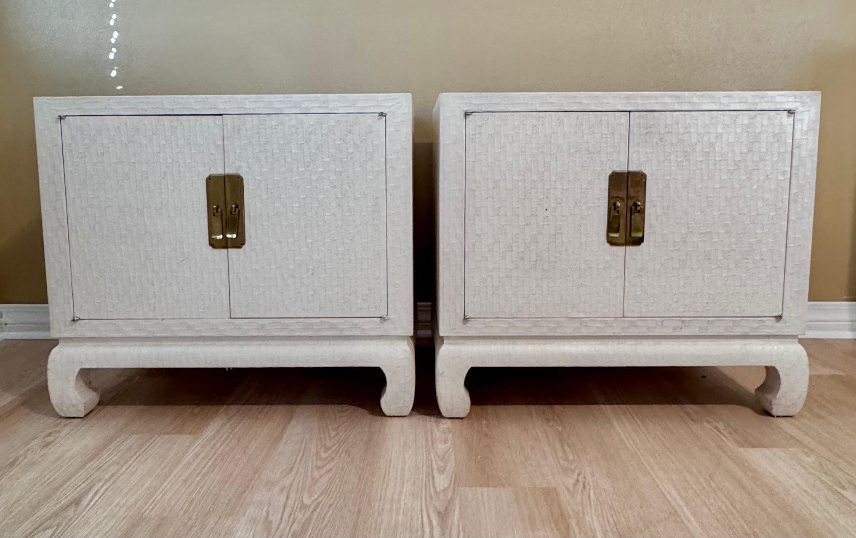 Chic, Rare find-- A fabulous pair of Hollywood Regency style grass cloth raffia cream lacquer mid century Nightstands by Baker Furniture. Feature a smooth, glossy lacquered grass cloth and a sleek, rectangular silhouette-epitomizing the
