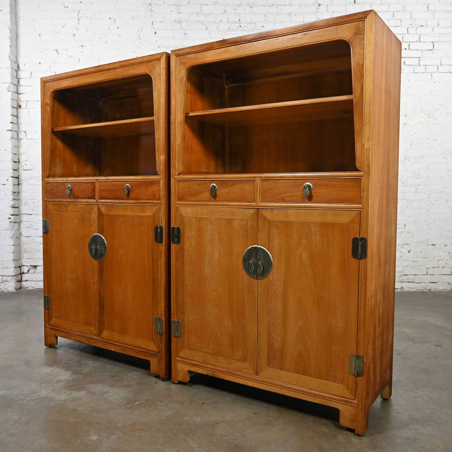 Wonderful vintage Asian Style chinoiserie Baker Furniture Far East Collection by Michael Taylor pair of cabinets. Comprised of natural elmwood with a matt finish and a bit of an antique Asian look, one top shelf, one lower shelf, and patinated brass