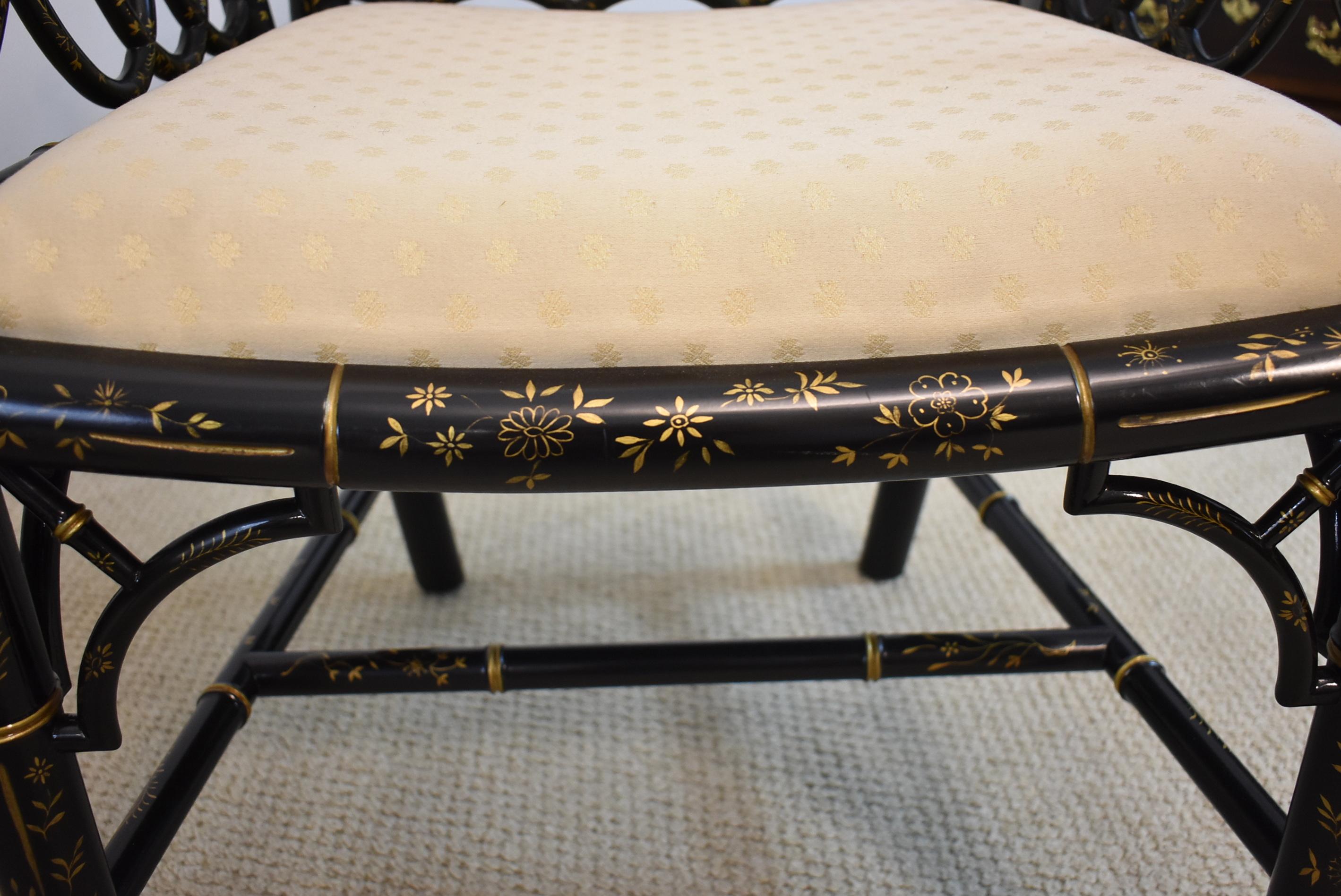 Pair of Baker Asian style ebonized armchairs with gilt highlights, and upholstered seats.