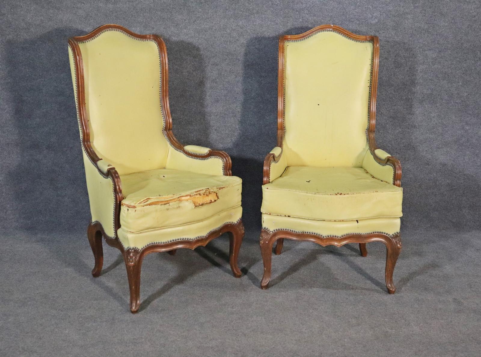Carved wood frames. Leather upholstery. Nail head trim. Measures: 45 7/8