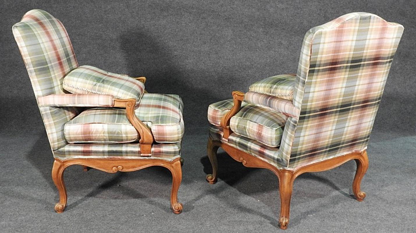 This is a fine pair of signed Baker armchairs in gorgeous pastel plaid upholstery which I believe is silk. The upholstery is in good condition with minor stains from use but nothing obtrusive or easy to see. These are from the 1970s era and in very