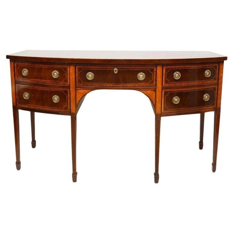 Pair of Baker Mahogany Satinwood Sideboards or Credenzas, 'Historic Charleston Collection', Bow Front

Fine condition. Pair of fully refinished Baker Furniture Console Tables featuring inlaid wood and classically wrought brass hardware. The subtly
