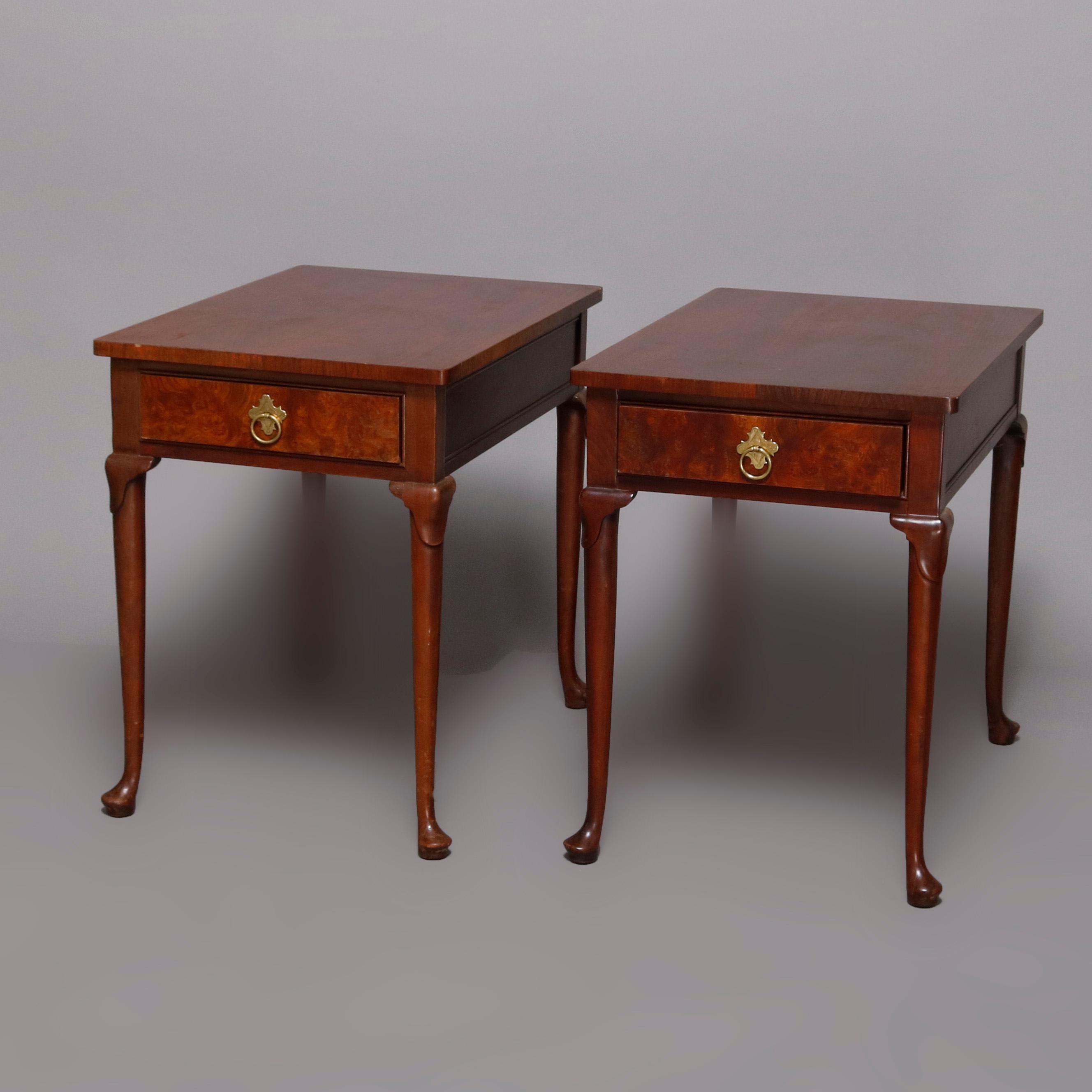 A pair of end stands by Baker Furniture Co. offer mahogany construction each with single burl drawer having brass pulls and raised on cabriole legs terminating in pad feet, Baker label on drawer interior as photographed, 20th century.

Measures: