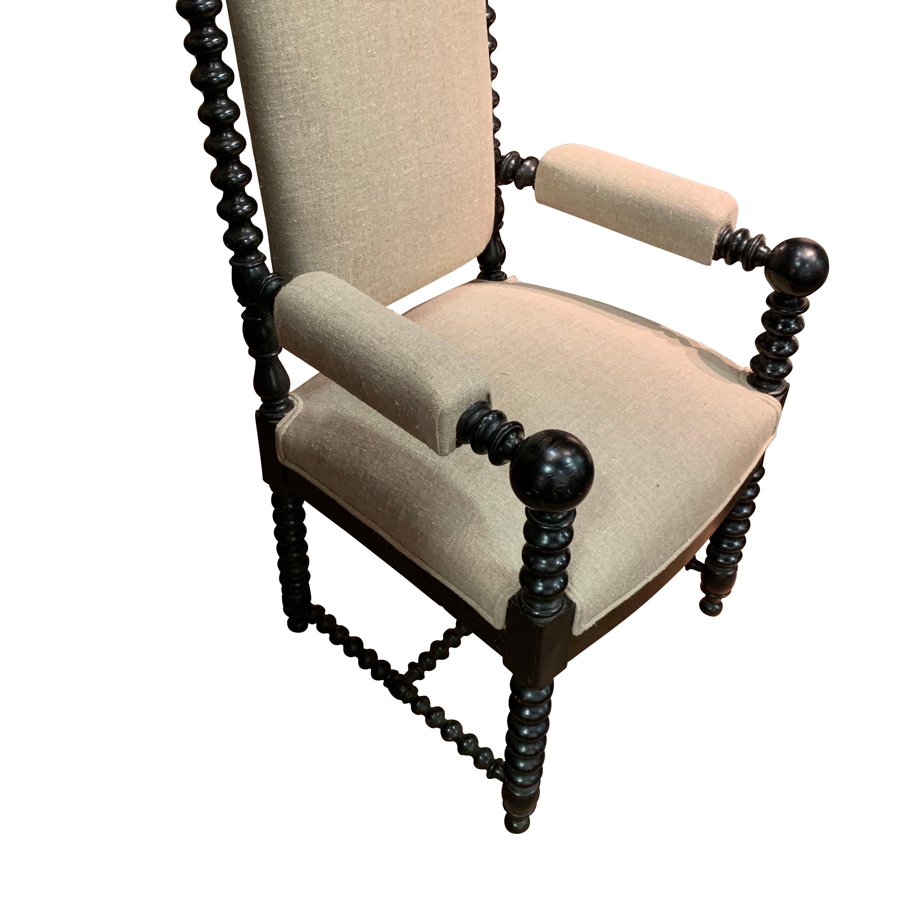 19th century French pair of ebonized ball armchairs with traditional spindle frame
Decorative finials atop sides of chair
Newly reupholstered back and seat in linen. 
Arms are also upholstered.

   