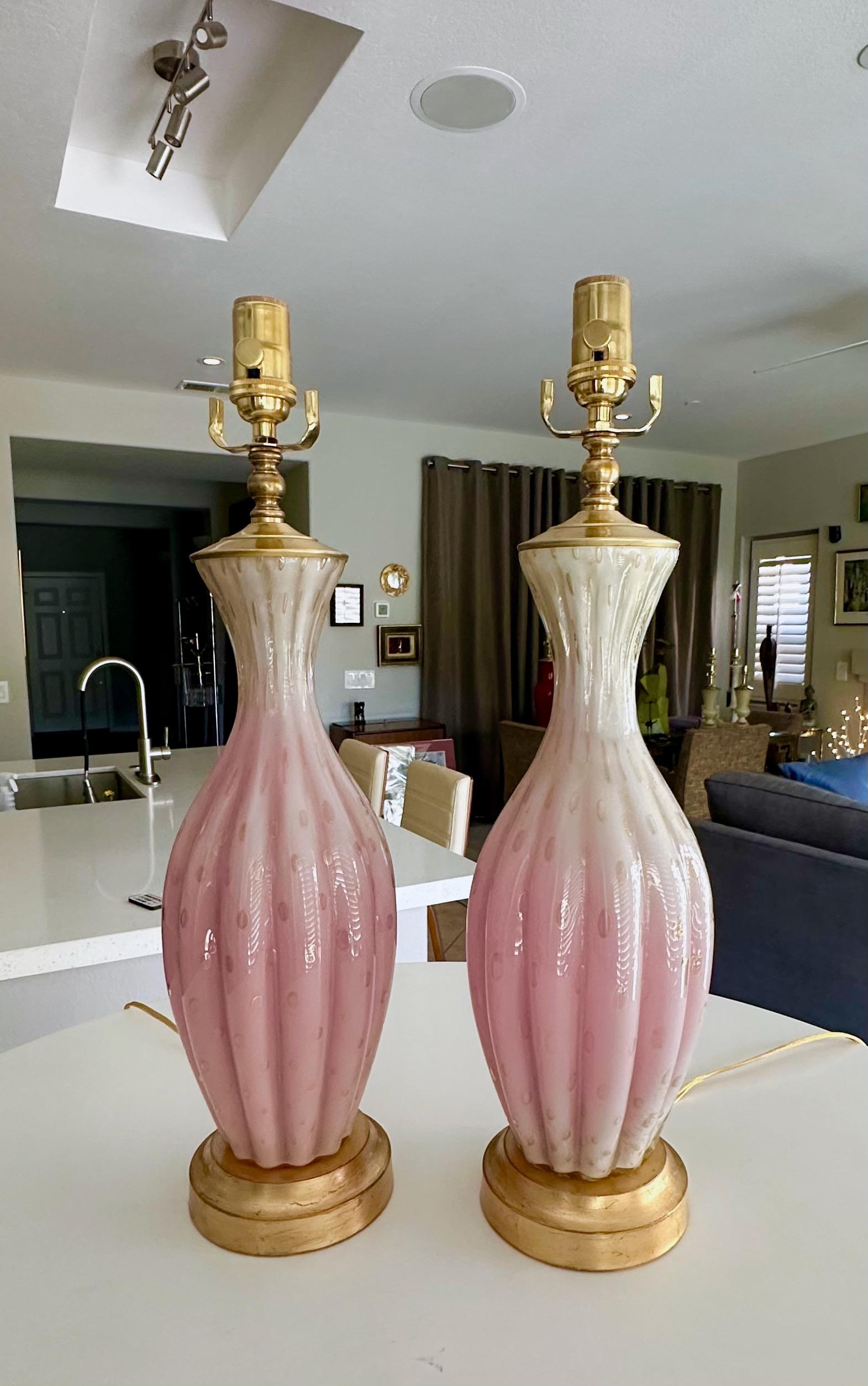 Pair of graduating white & pink fuchsia Barbini Murano glass lamps with control bubbles and gold inclusions. Mounted on gilt metal bases.Rewired with new brass 3 way sockets and cords. Shades not included. Overall height top of socket 22
