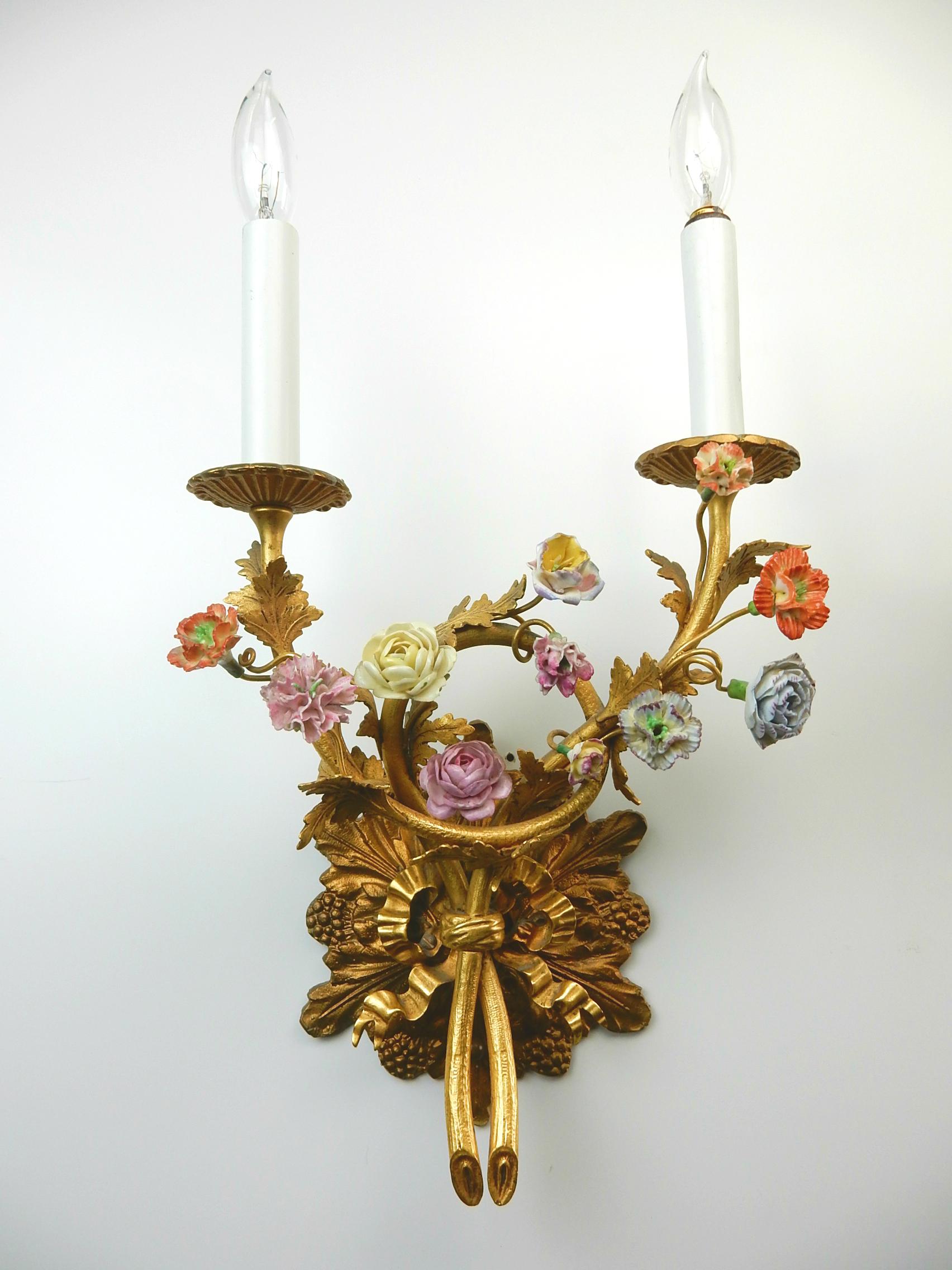 Fabulous pair of floral wall lamp sconces circa 1960s.
Gilded metal with organic floral design each tipped with a hand painted
porcelain flower.
These come with hardware to mount to any standard electrical box.