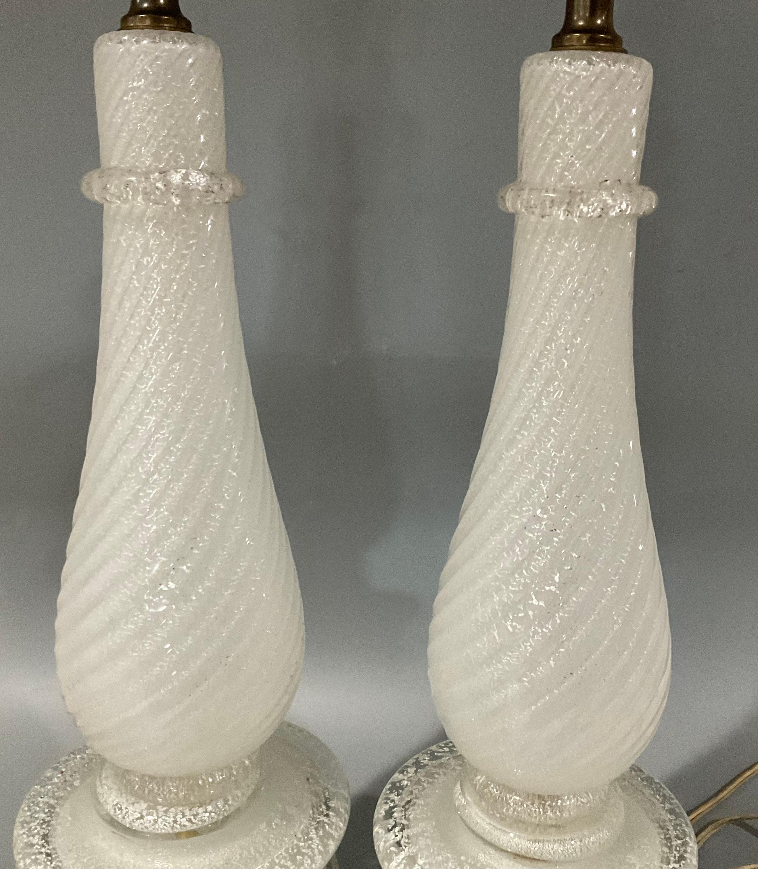 Pair Barovier and Toso Murano glass lamps by Ercole Barovier white with silver flecks. Applied clear band and applied circular rings. Glass height is 17.25. Measurements without harps as given is 21 1/4 inch height by 5 1/2 inches.