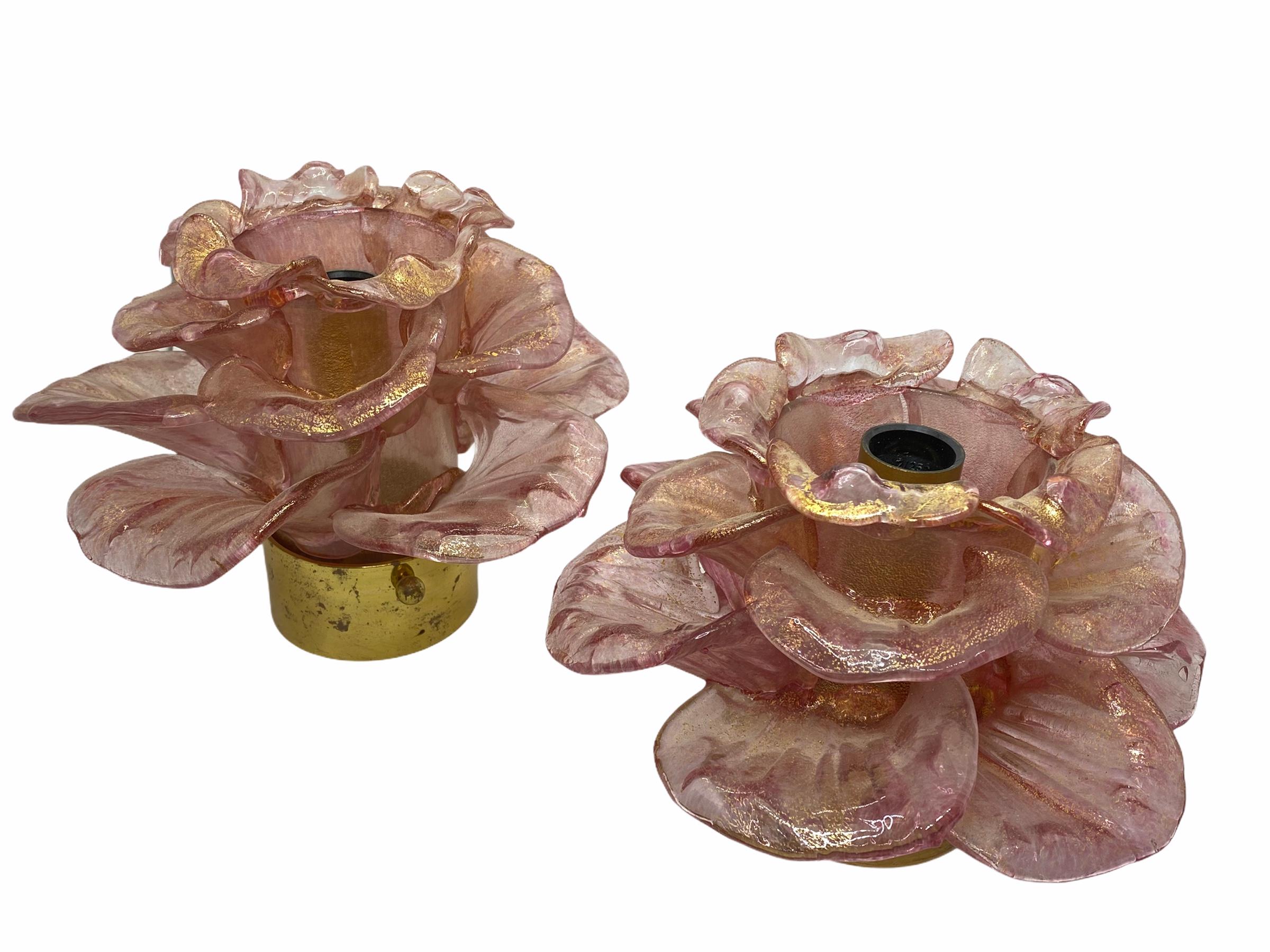 A petite pair of hand blown Italian flush mount or wall lights featuring flowers, old rose colored with 23-carat gold leaf fleck inclusions, mounted on a brass frame. Each fixture requires one European E14 / 110 volt candelabra bulb, bulb up to 60