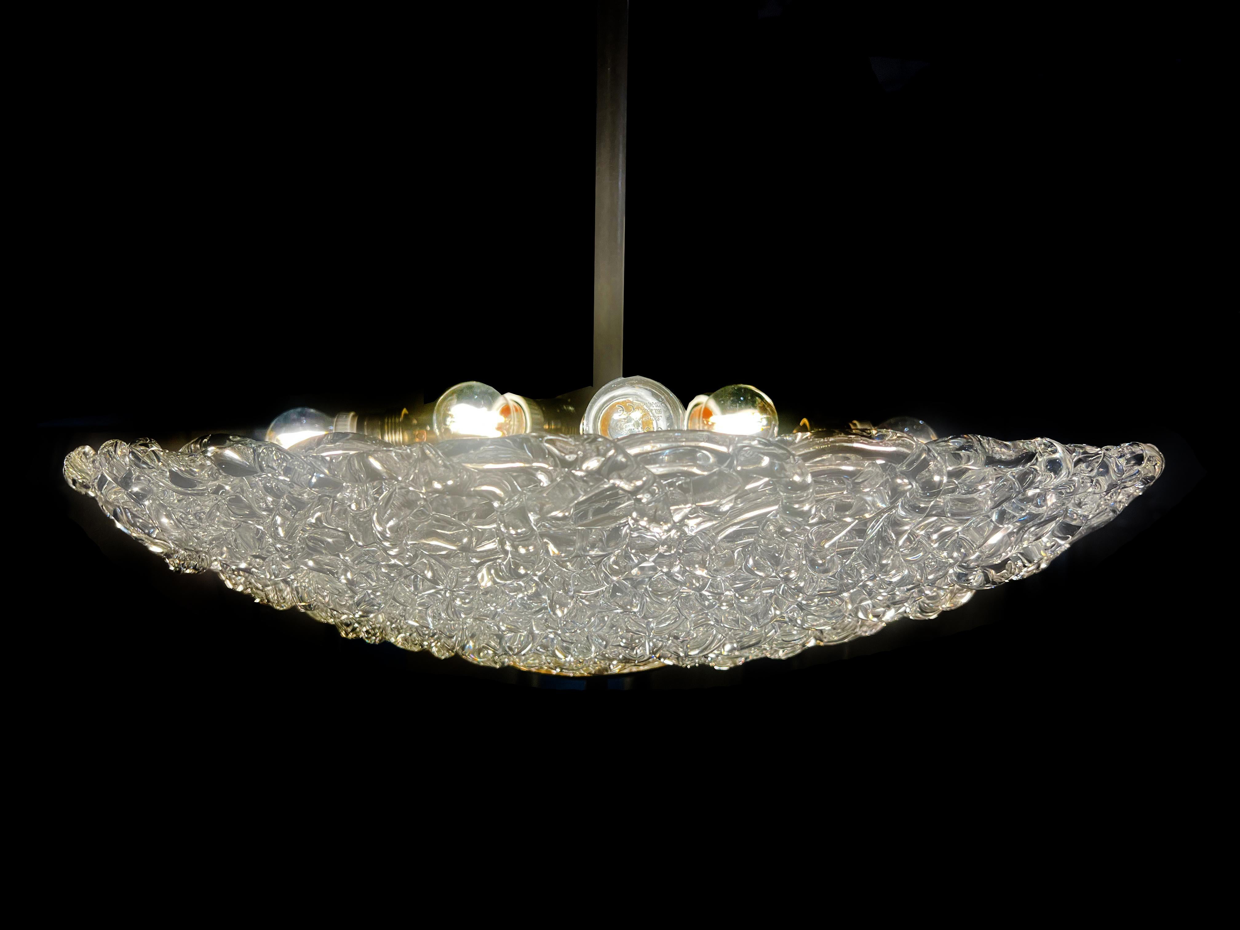Extraordinary pair of pendants by Poliarte. A spider web of pure Murano glass with great luminous impact. 
Eight lights per chandelier. 