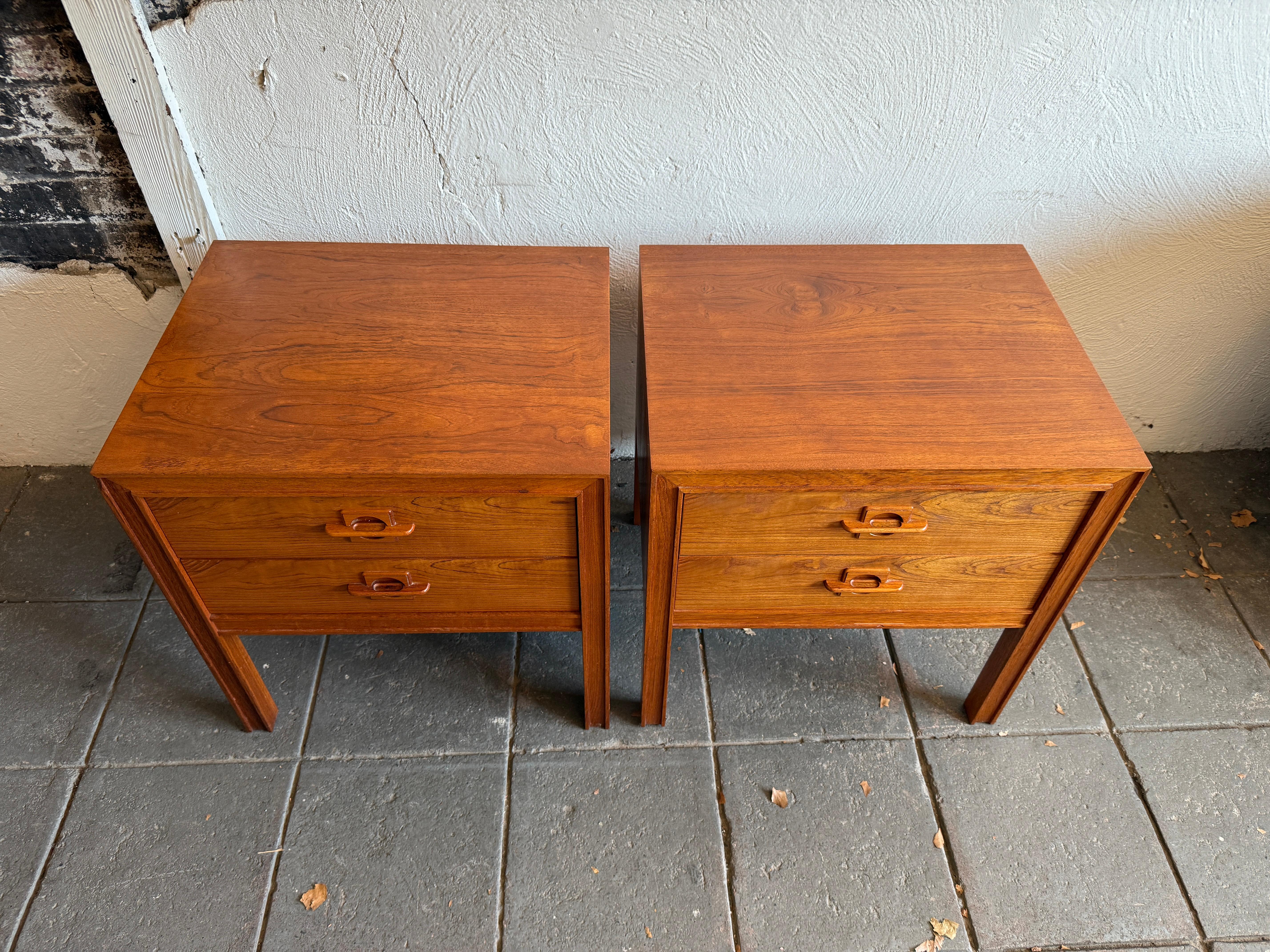 Stunning Pair Beautiful teak danish modern 2 drawer nightstands Brande Møbelfabrik. Set of (2) Drawer Golden brown teak wood nightstands or bedside tables. Excellent design and fabrication. Solid carved teak handles with Danish control Logo on