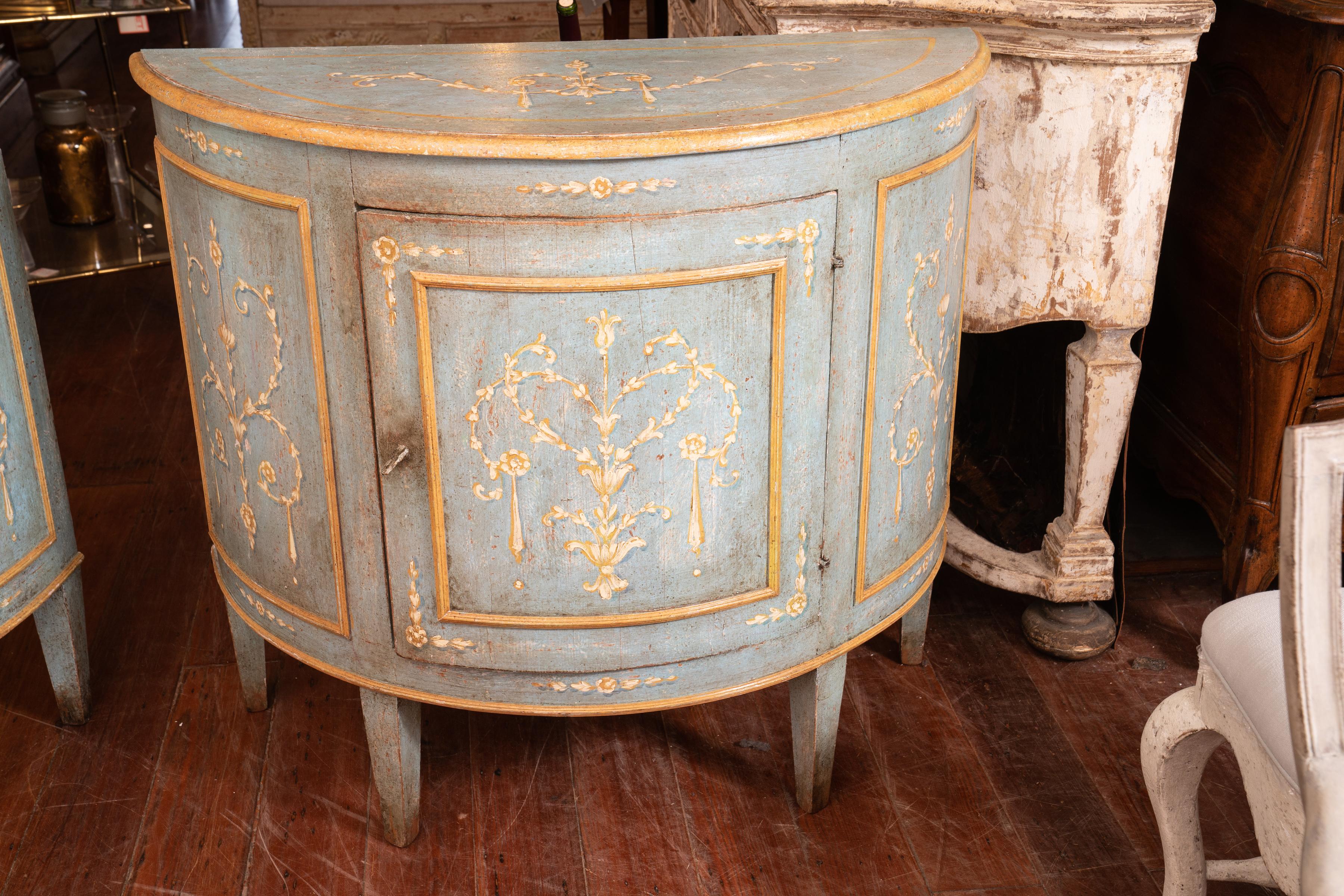 Beautifully painted pair of demilune buffets with original paint. Muted colors can fit in with any décor, circa 1890.