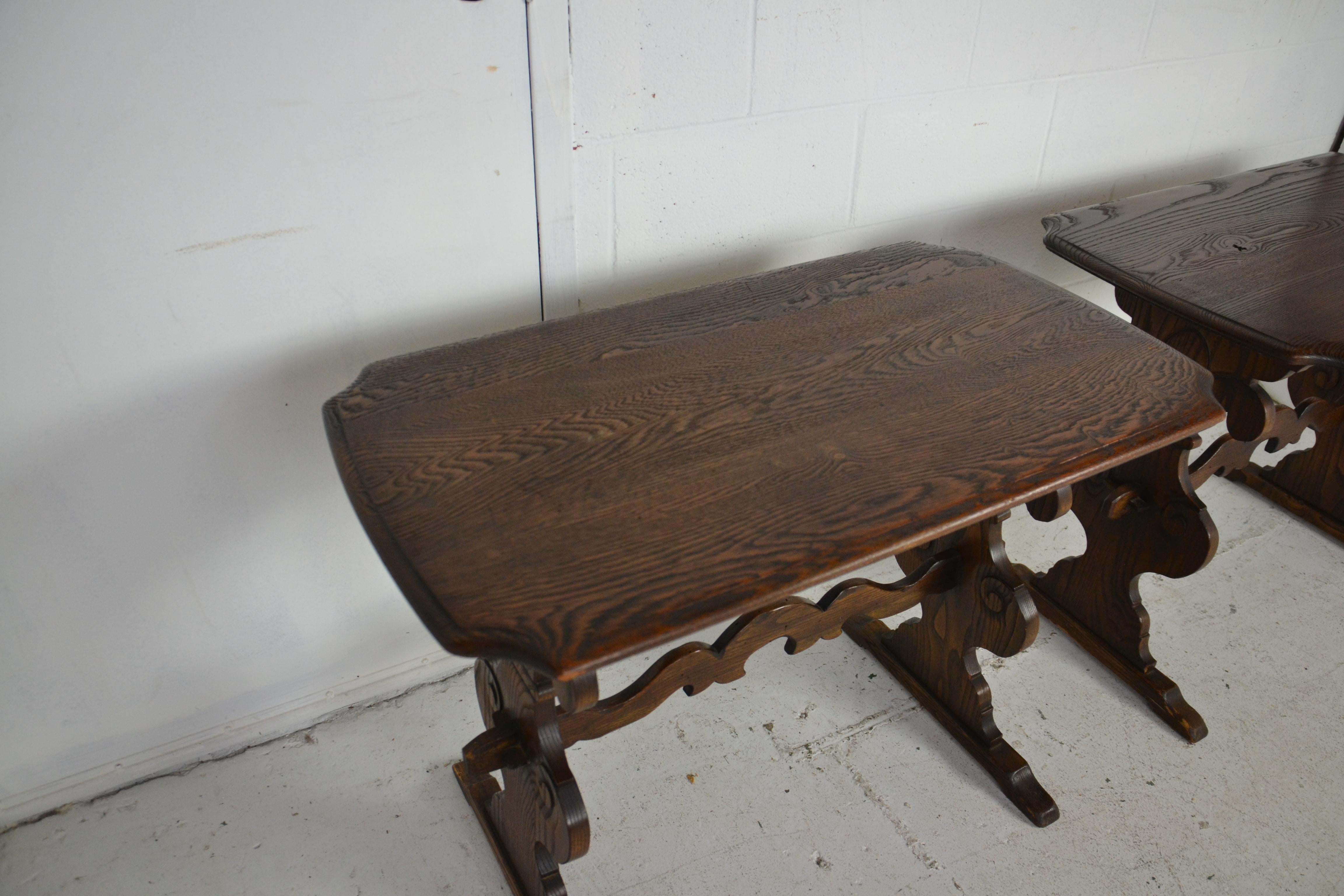 A pair of oak end tables by Berkey & Gay with trestle style bases.