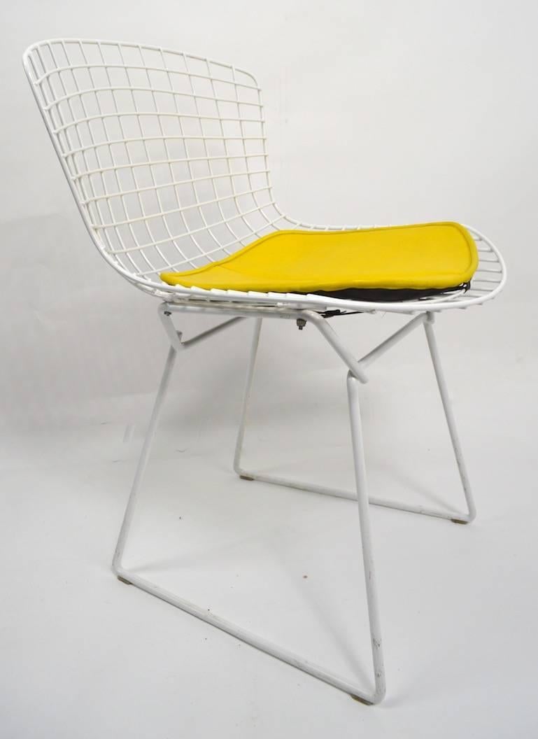 Nice pair of dining chairs designed by Bertoia for Knoll. Matched pair, both in very good, original condition, both retain Knoll 655 Madison Ave labels (circa 1980s). Measures: Seat H 18 inches. Priced and offered individually, but we would love to
