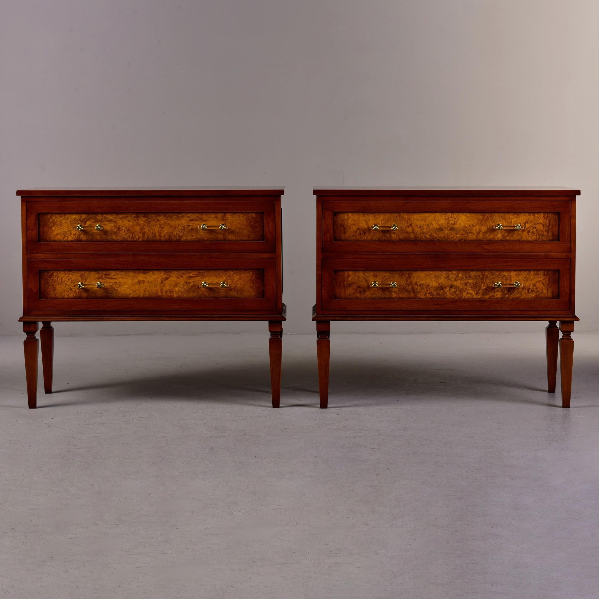 This pair of two drawer walnut chests was custom made for us in England. Classic lines with dovetail construction, contrasting burlwood drawer fronts, lucite and brass hardware and tapered legs. Versatile size can be used for bedside cabinets or to