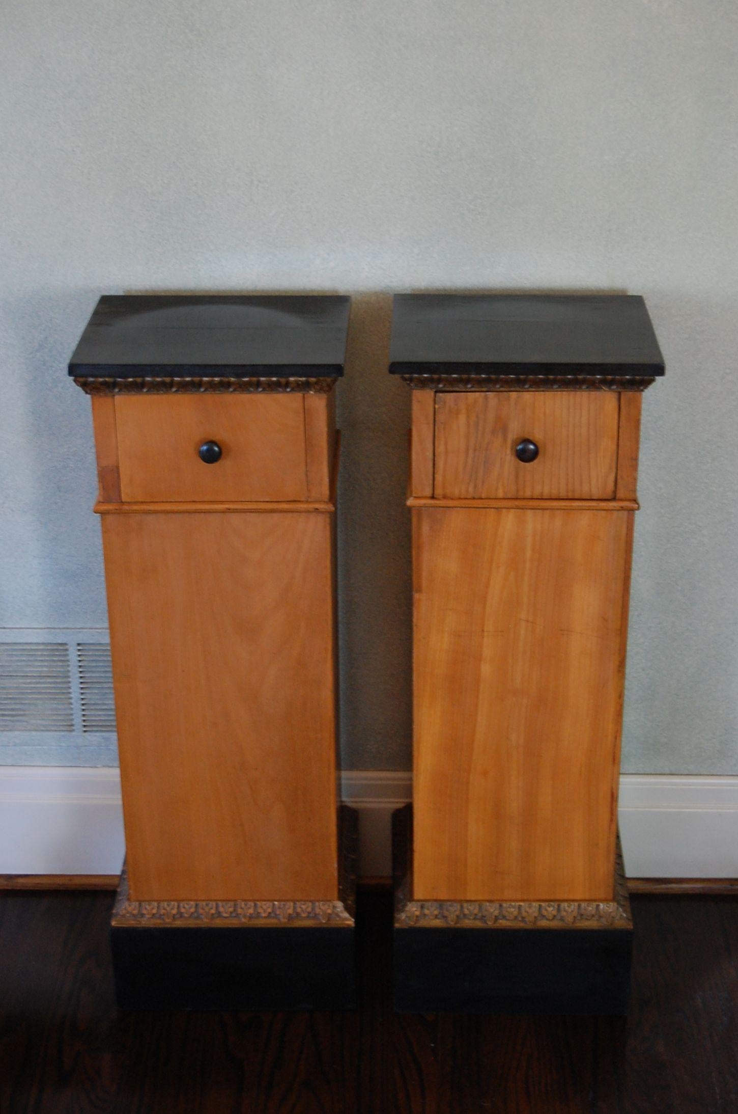 A pair of Biedermeier fruit wood stands with black lacquered tops and a single drawer, gold leaf trim along base cap, possibly French or German in origin. Parke Interiors purchased them some 50 years ago from the New Orleans residence of the late