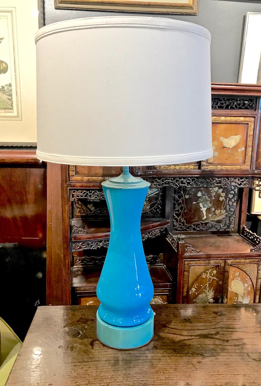 This is a striking pair of midcentury blue opaline lamps attributed to Billy Haines. Although not signed, the lamps' tall lacquered bases with a beaded detailed; the type of electrical fittings which have been painted to match the lacquered base;