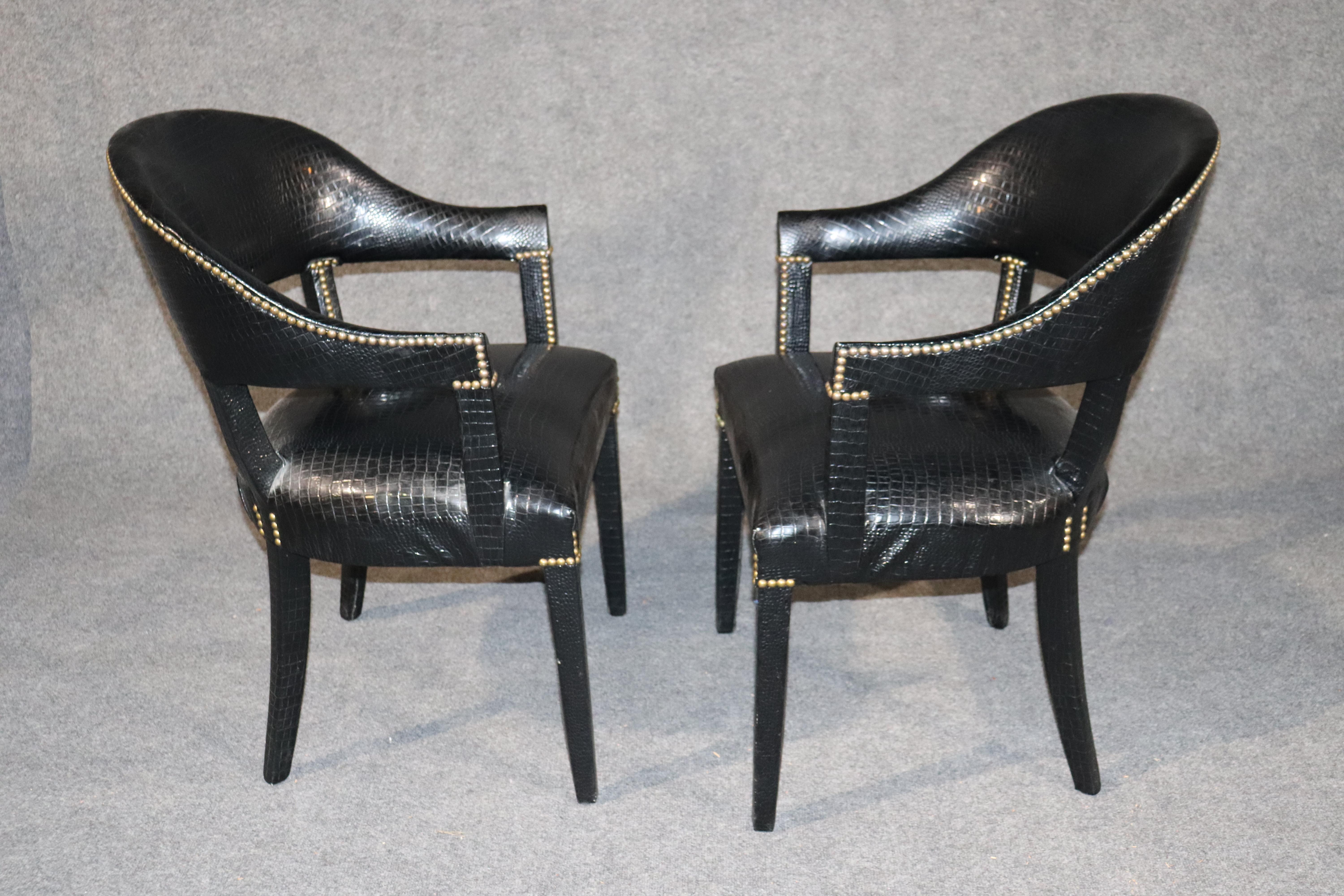 This is a beautiful pair of alligator-printed faux leather and mahogany chairs. They are perfect for a living room or even an office at the front of a desk. The chairs date to the 1980s and are in good condition. The chairs measure 34 tall x 24 wide