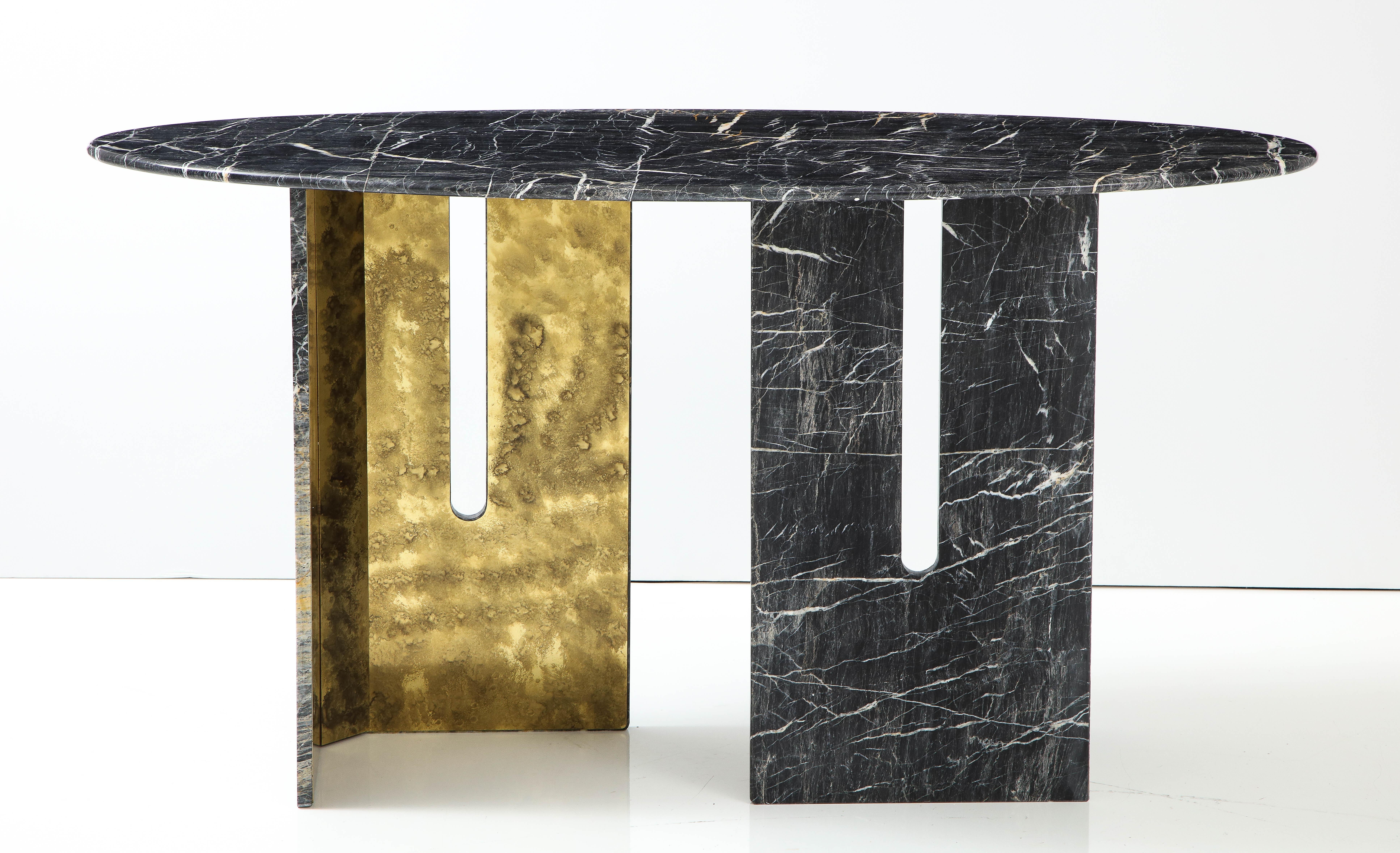 One-of-a-kind pair of Saint Laurent black and grey with White Veins marble Consoles Tables. Oval-shaped, polished marble slabs sit atop geometric bases that are set in an asymmetrical arrangement. Legs consist of marble on the exterior with oxidized