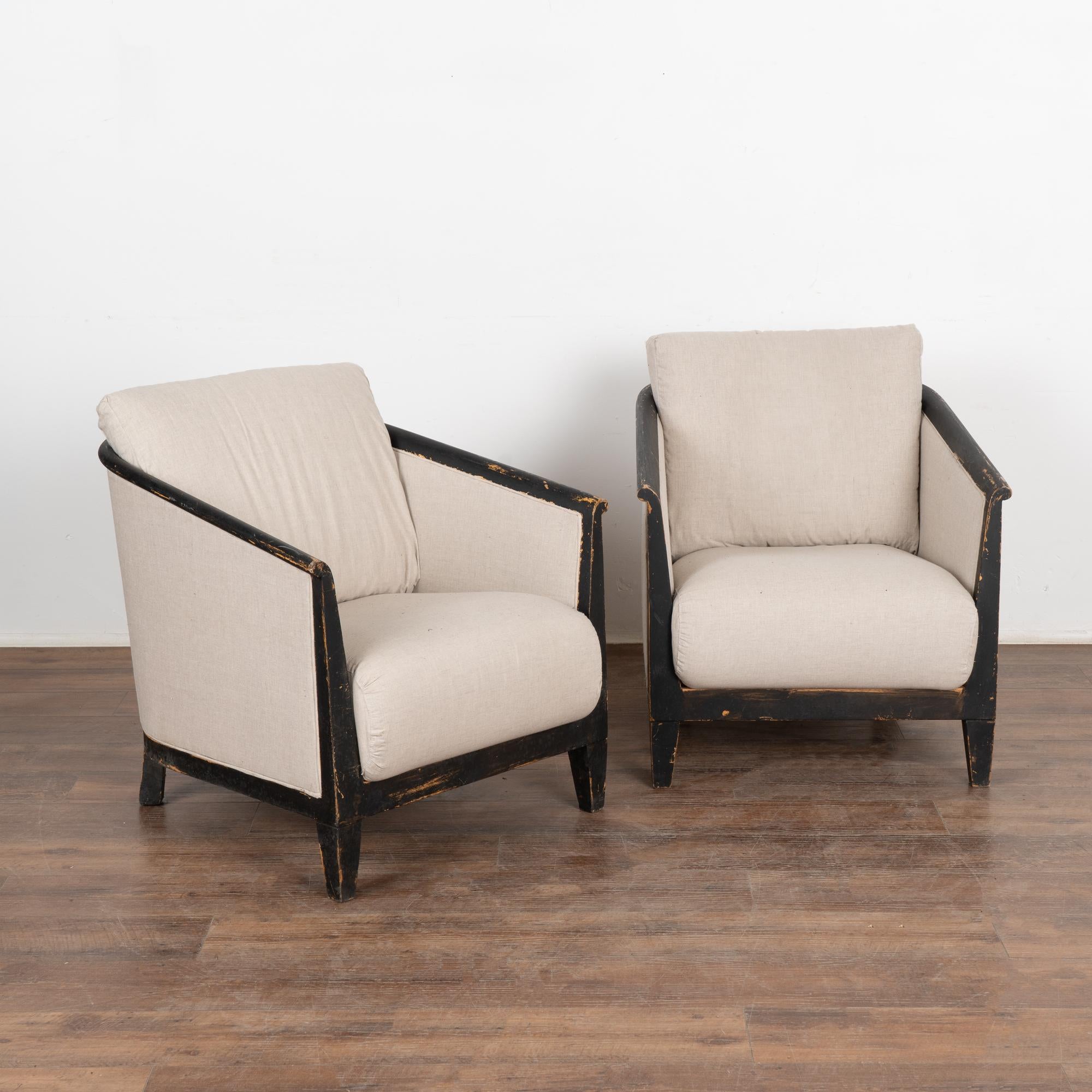 This pair of Swedish arm chairs has timeless clean lines with a squared view in front and barrel curve to the back due to the attractive 