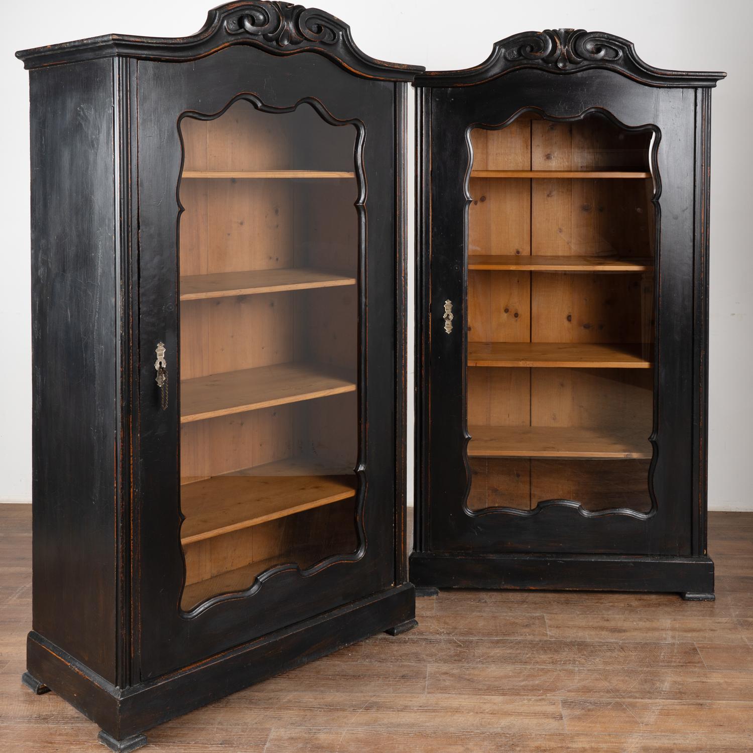 These exceptional bookcases are a tremendous find as it is difficult to find a matching pair. The professionally applied (newer) black painted finish is lightly distressed to fit the age and character of the pair.
These pine display cabinets have