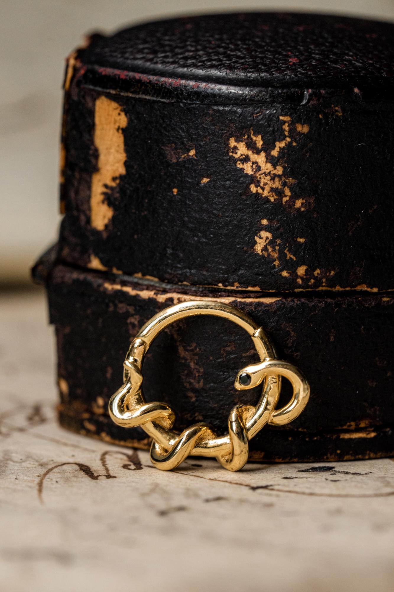A pair of black diamond snake earrings in solid 14k yellow gold. The earrings are set with 0.02 CT black diamond each with a total weight of 0.04 CT.
Can also be worn as a nose or ear piercing. If you would like to order a single earring, please