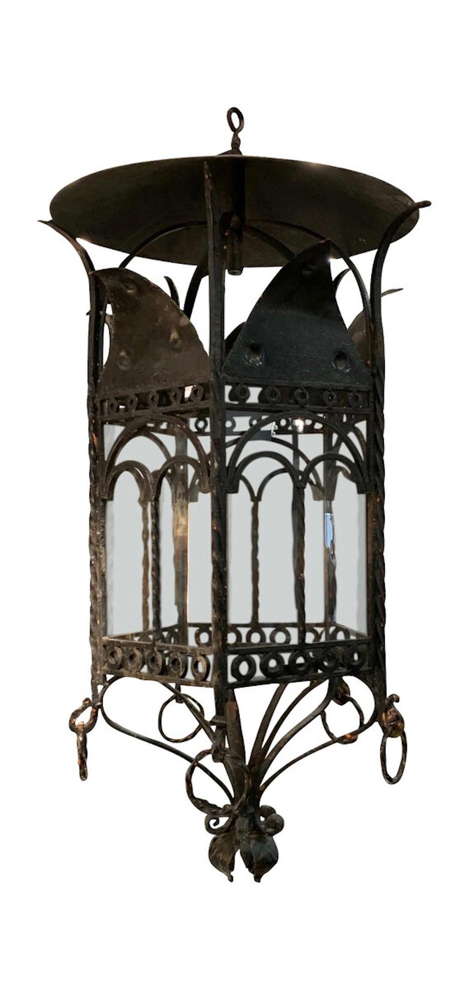 1940s French pair of black iron hexagonal shape lanterns having a unique and decorative design.
Natural patina on the iron.
The lanterns are newly rewired.
Four light candelabra cluster, 60 watt maximum each.
 