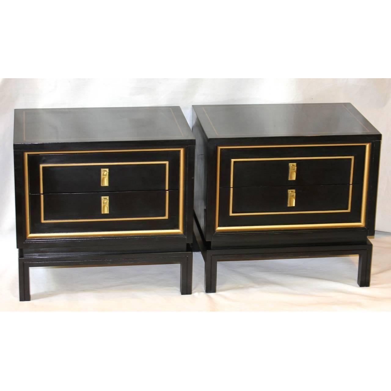 Pair of black lacquered and gold painted detailing nightstands or end tables by American of Martinsville. The Dorothy draper inspired nightstands have attractive brass pulls and two pull-out drawers.