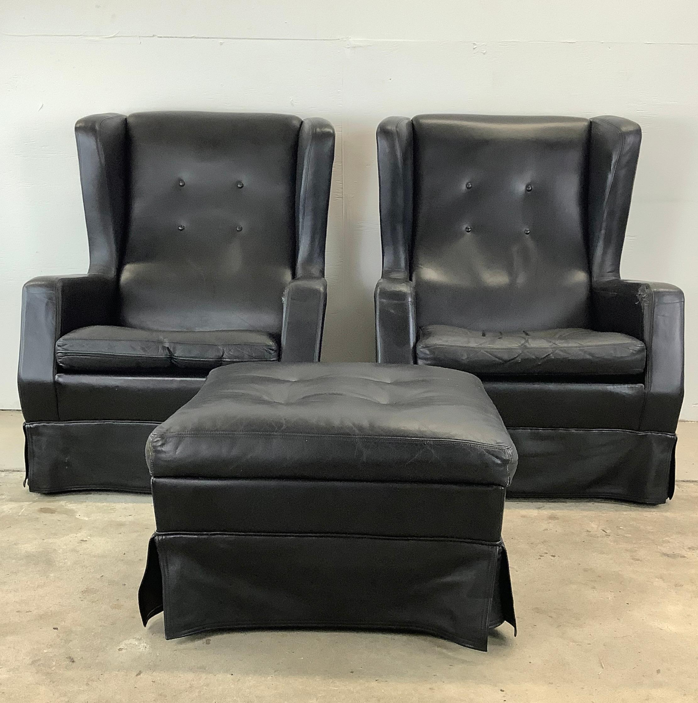 This captivating vintage seating set includes a pair of high Wingback Armchairs and matching ottoman, designed for acclaimed Dutch manufacturer Artifort by Theo Ruth. This striking pair of wingback chairs are elegantly upholstered in rich black
