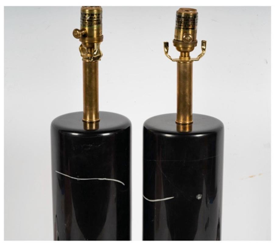 This is a classic pair of Visual Comfort Black Marble lamps that are the personification of simplicity.  Simple columns of black marble with minimal crystal inclusions mounted on brass bases and fitted with exceptional quality electrical fittings.