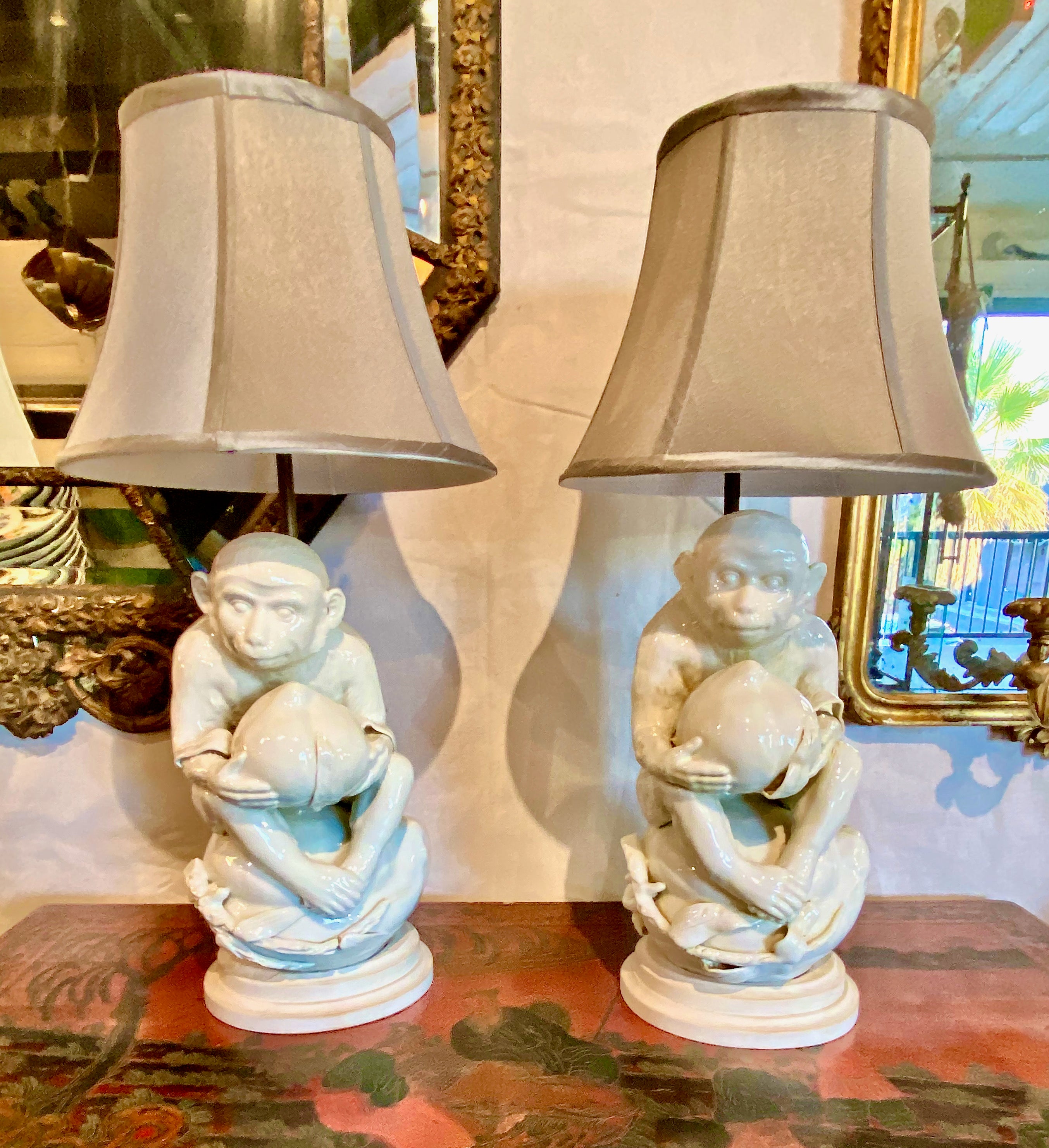 This is a great pair of unique mid-century Coastal Style blanc de chine monkey lamps. I believe that the monkey sculptures are German porcelain and date to the late 19th or early 20th century as there is a number to the bottom and the porcelain does