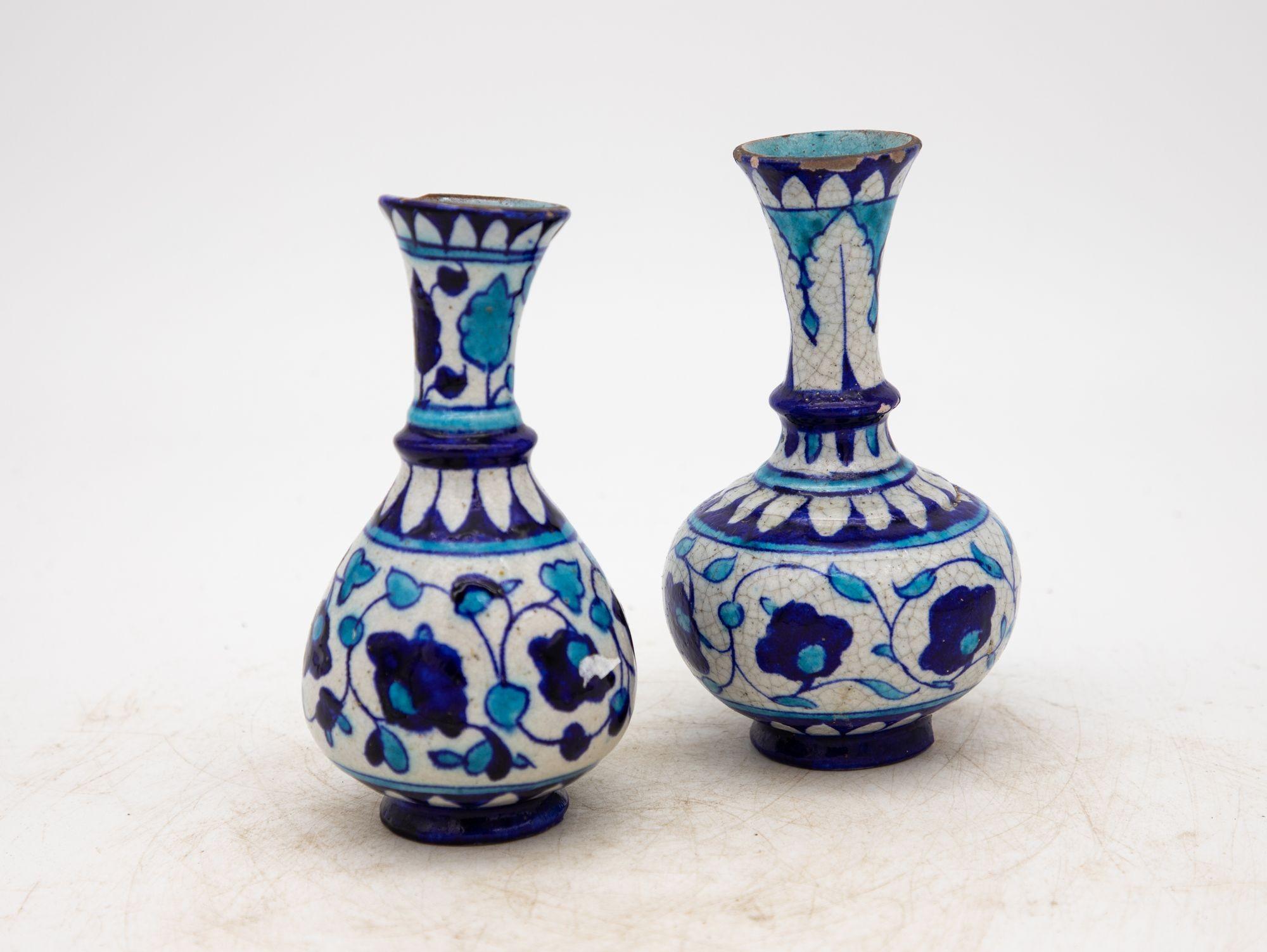 Dating back to the 1890s, this exquisite pair of Iznik vases epitomizes the timeless allure of Turkish pottery. Adorned with the iconic cobalt and turquoise hues against a white backdrop, these vases exude the classic charm that defines Iznik