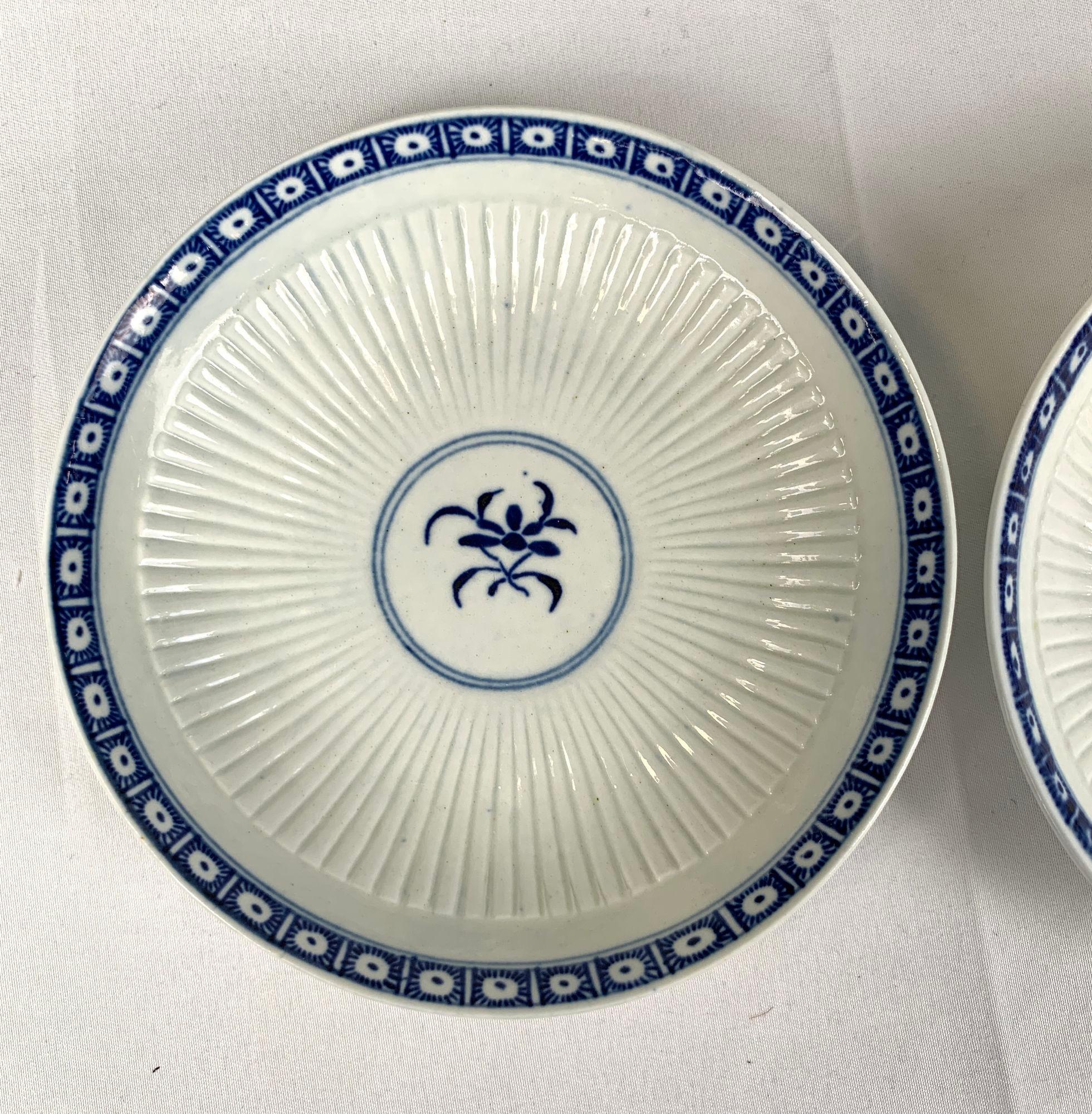 This lovely pair of blue and white First Period Worcester porcelain saucers is decorated in the elegant Dark Sprig Centre pattern.
First Period Worcester is also known as Dr. Wall Worcester.* The saucers were made at the Worcester factory circa