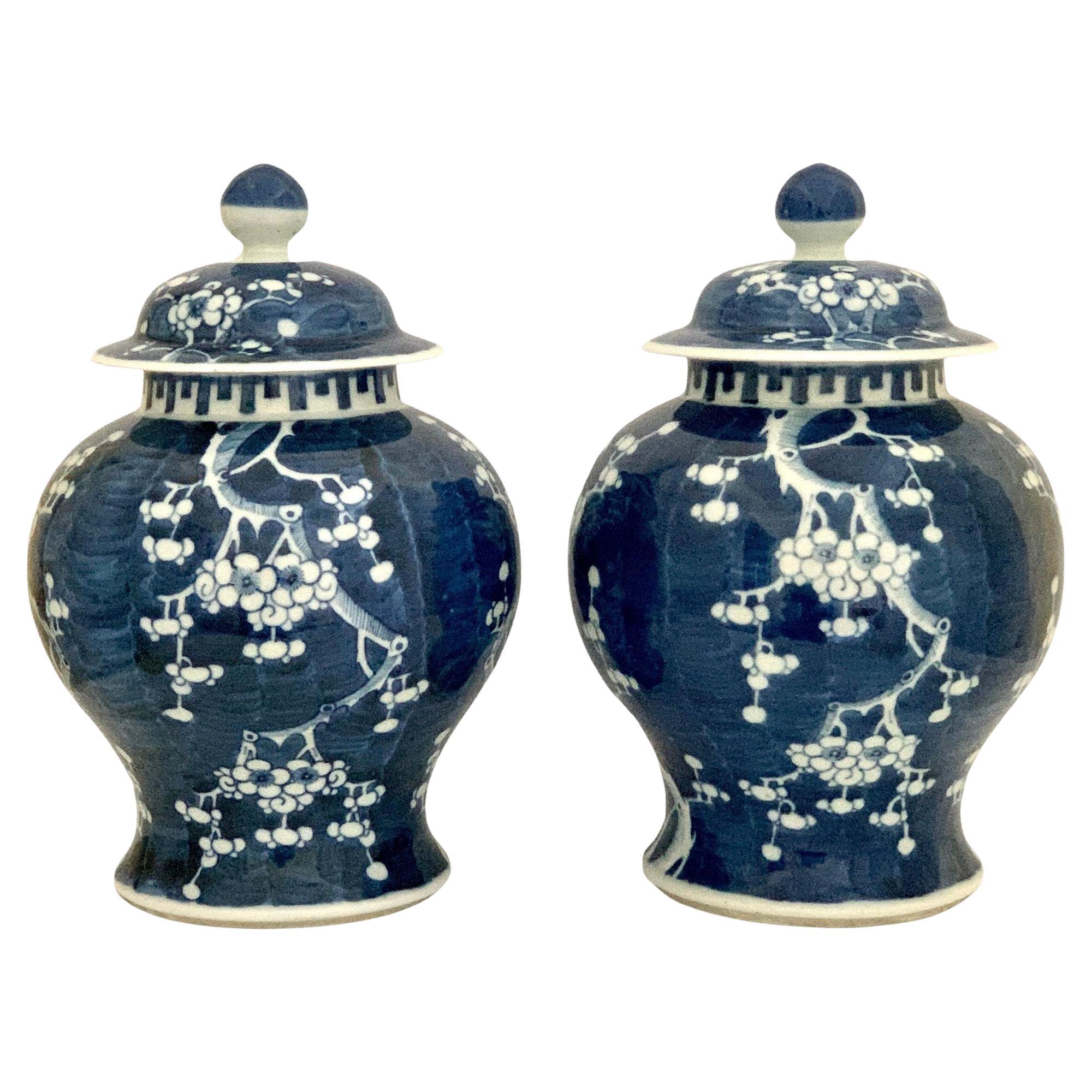 This pair of Chinese Blue and White ginger jars were hand painted in the late 19th century during the Qing Dynasty transitional Tongzhi-Guangxu period.
The jars are decorated in cobalt blue with an allover prunus blossom pattern reserved in white