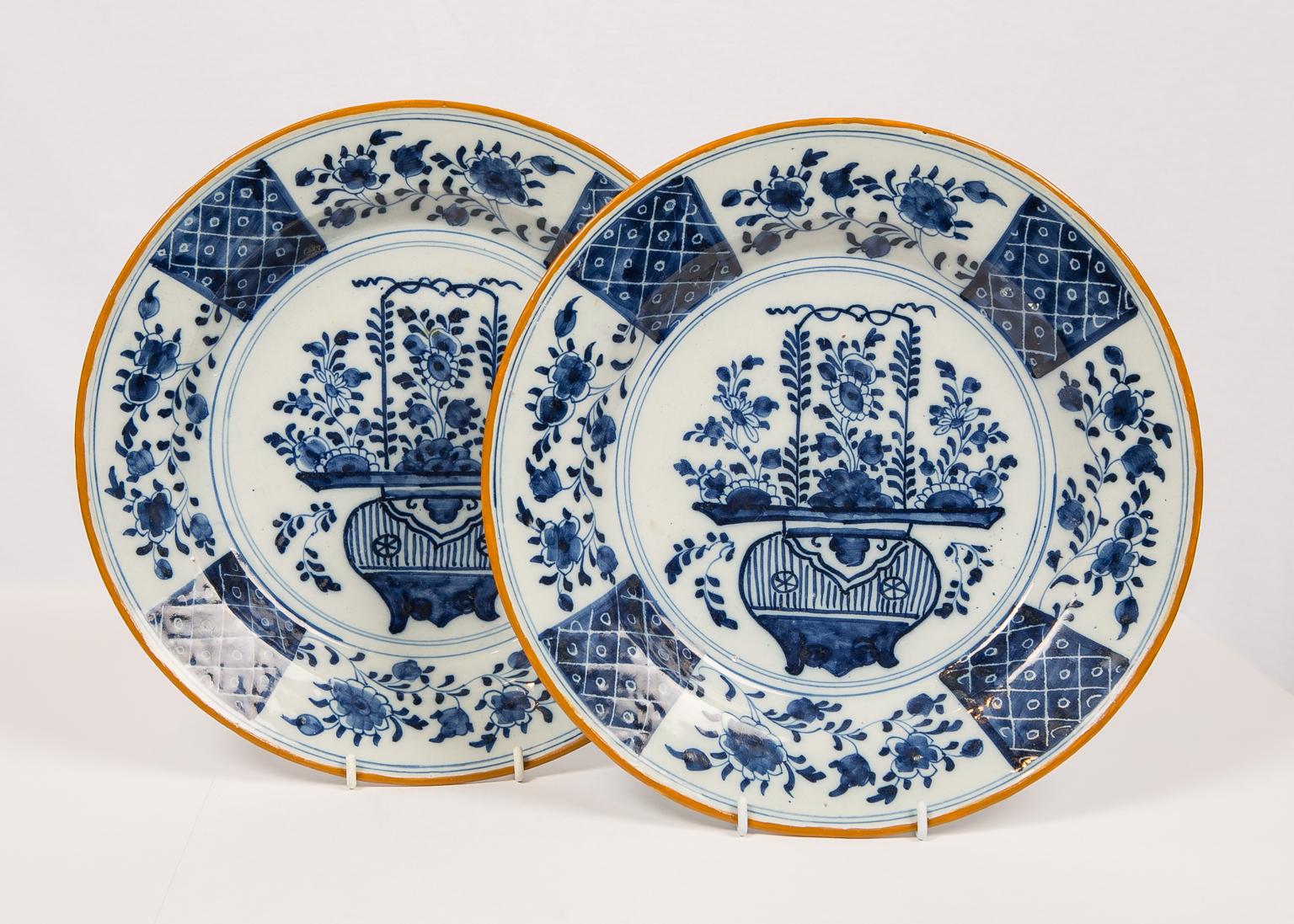 We are pleased to offer this pair of blue and white Delft chargers are each decorated in the center with a large but delicate vase filled with chrysanthemums and peonies. The chinoiserie design on the center of the platter is derived from Chinese