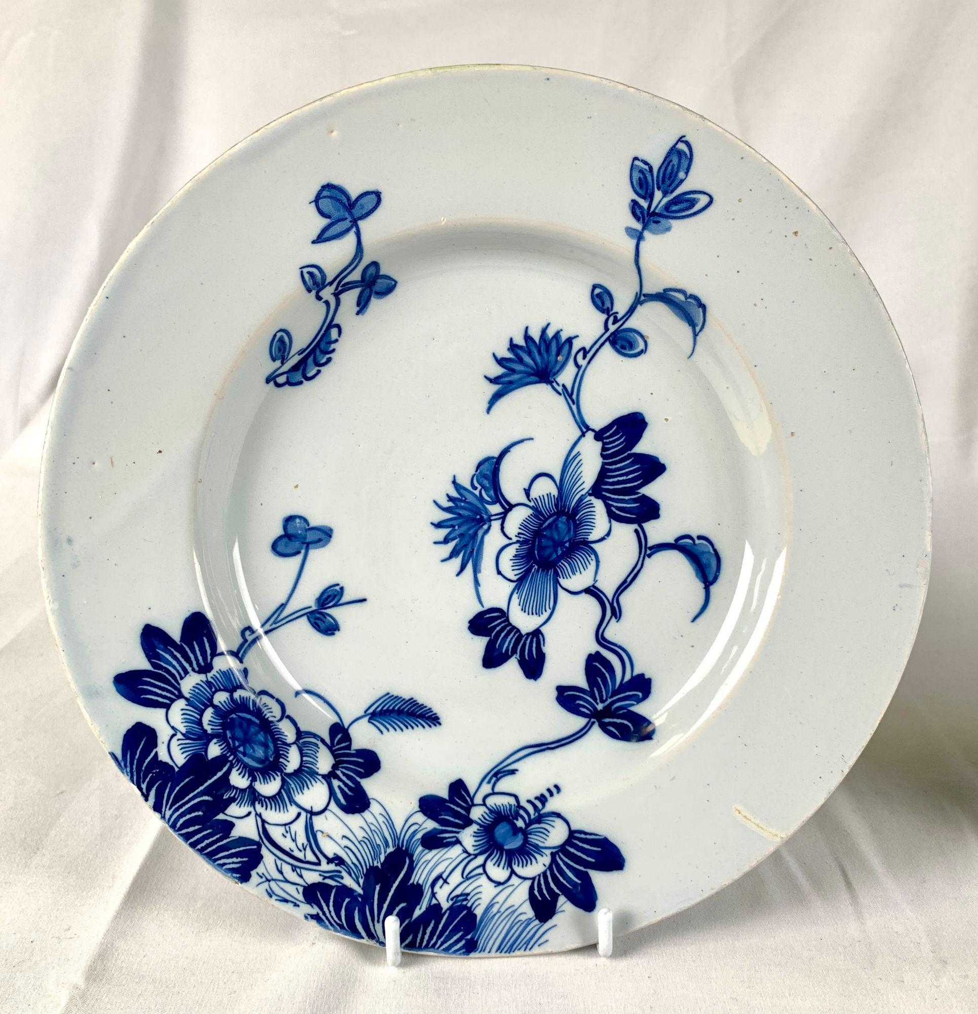This gorgeous pair of blue and white English Delft plates was made in Bristol, England, circa 1760.
The lovely floral decoration is hand painted in shades of cobalt blue on a light cobalt blue ground.
One flower on the vine stretches rim to rim from