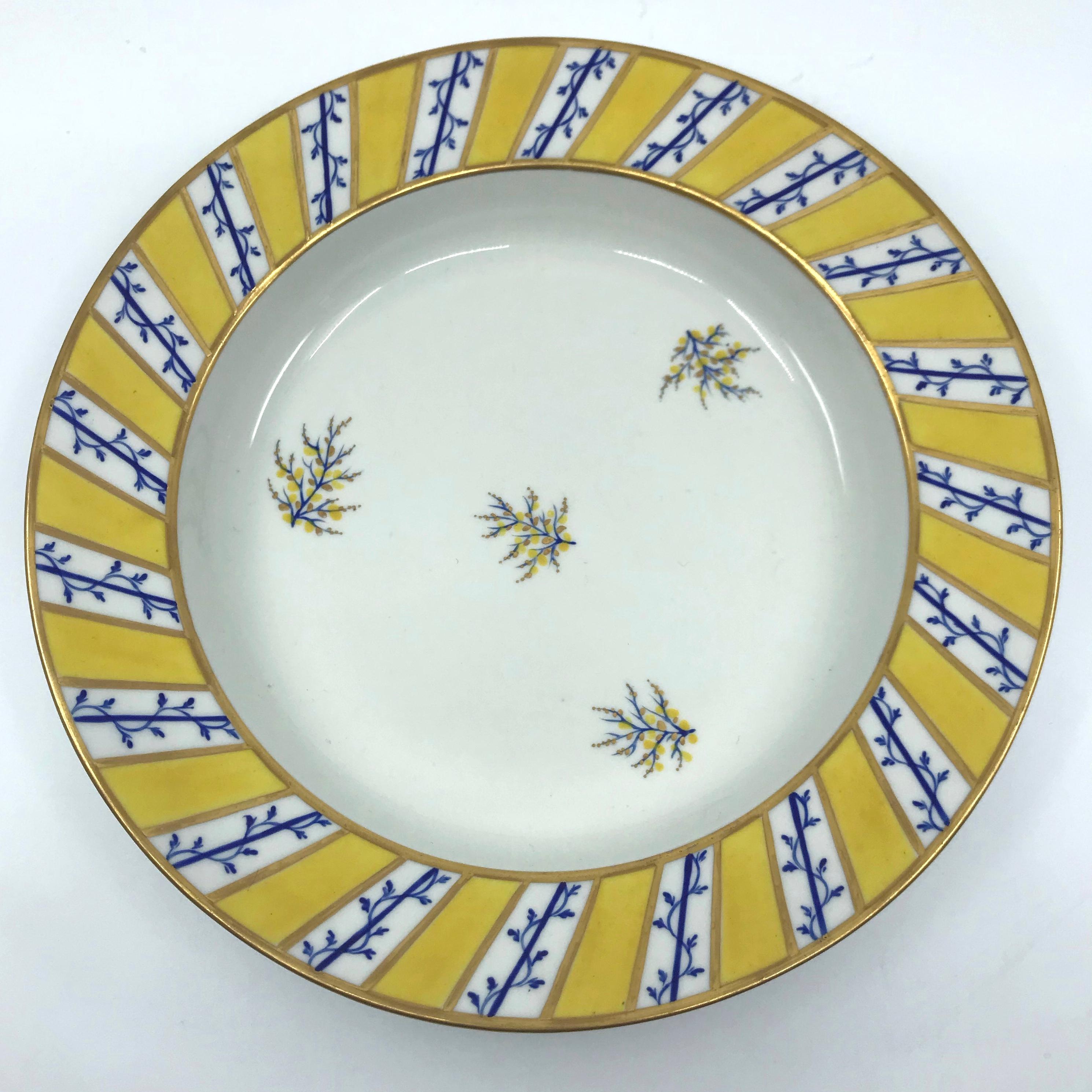 Pair blue and yellow gilt Derby soup plates. Pair hand-painted and gilt soups with alternating yellow and white striped gilt banded border with blue floral stems surrounding five blue yellow and gilt floral sprigs on a white ground. Puce under