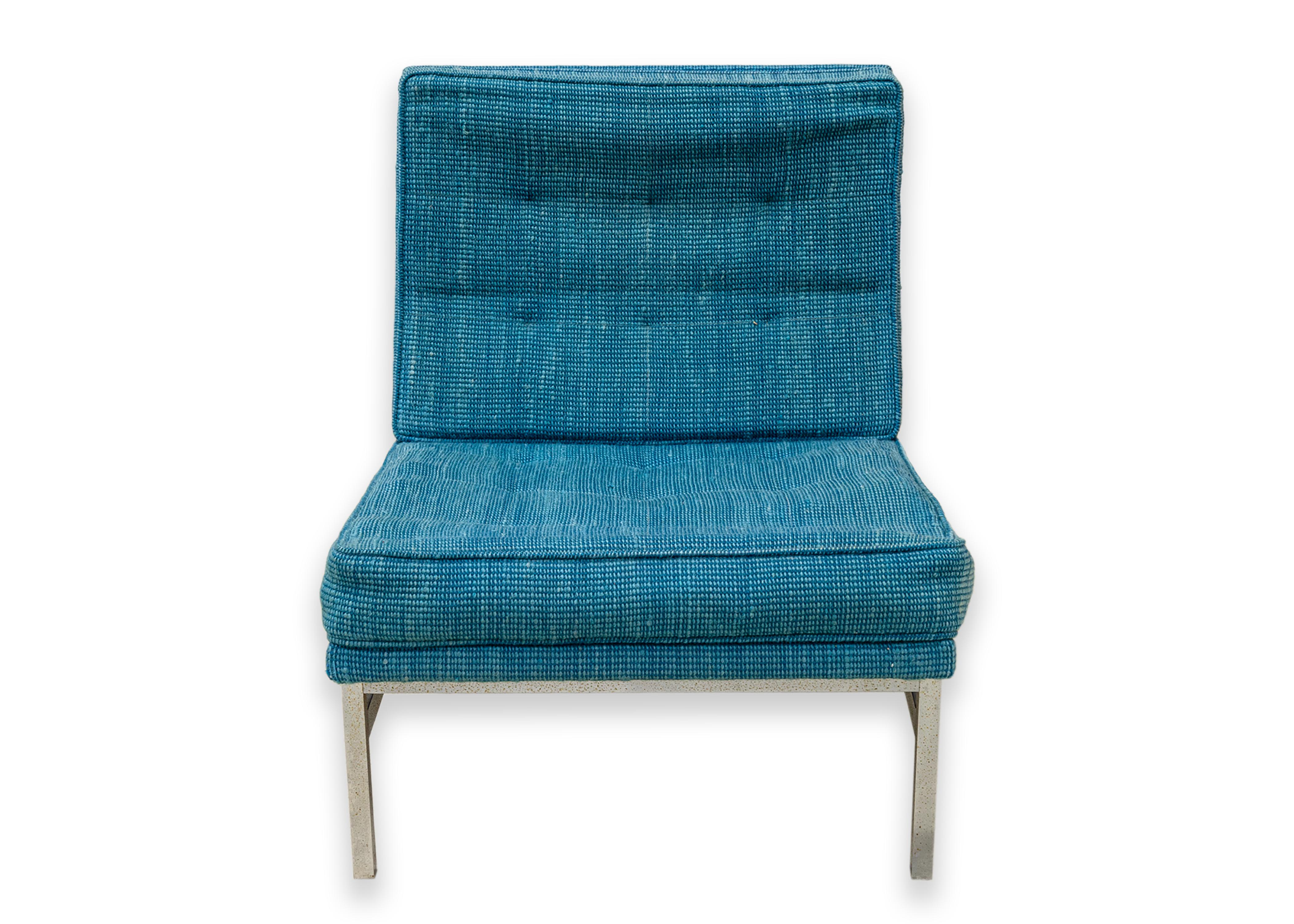 A pair of Florence Knoll blue parallel bar accent chairs. A classic set of mid century modern design chairs featuring a beautiful blue fabric upholstery. This classic design features a heavy metal chrome frame with rectangular shapes. The seat sits