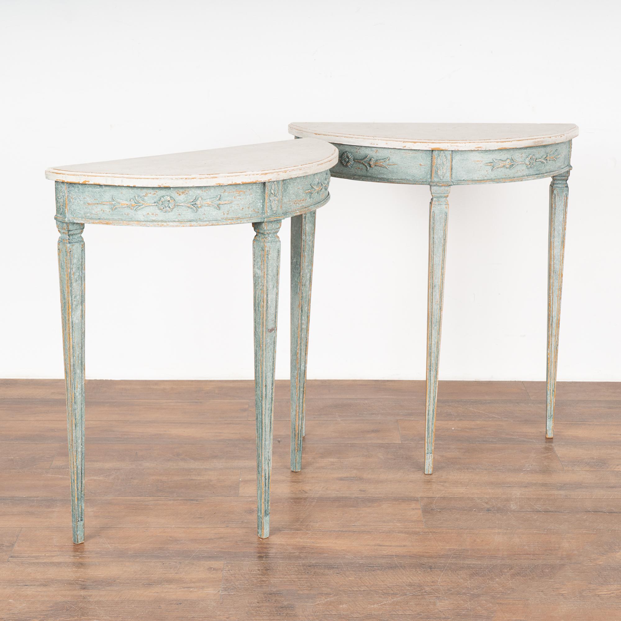 This enchanting pair of antique demi lune tables are from Sweden; note the slender tapered/fluted legs and lovely skirt with applied carving.
Both these side tables are finished with a newer, professionally applied layered blue paint and