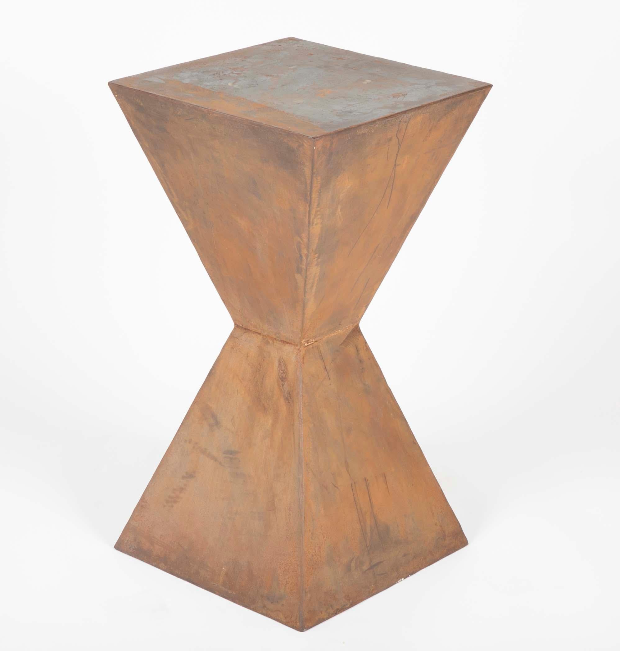 Compelling pair of geometric steel side tables or pedestals very much in the style of Constantin Brancusi. With a soft rust colored patina, these will make great lamp stands or wonderful pedestals for sculpture or other objects. 
Measures: 28.4