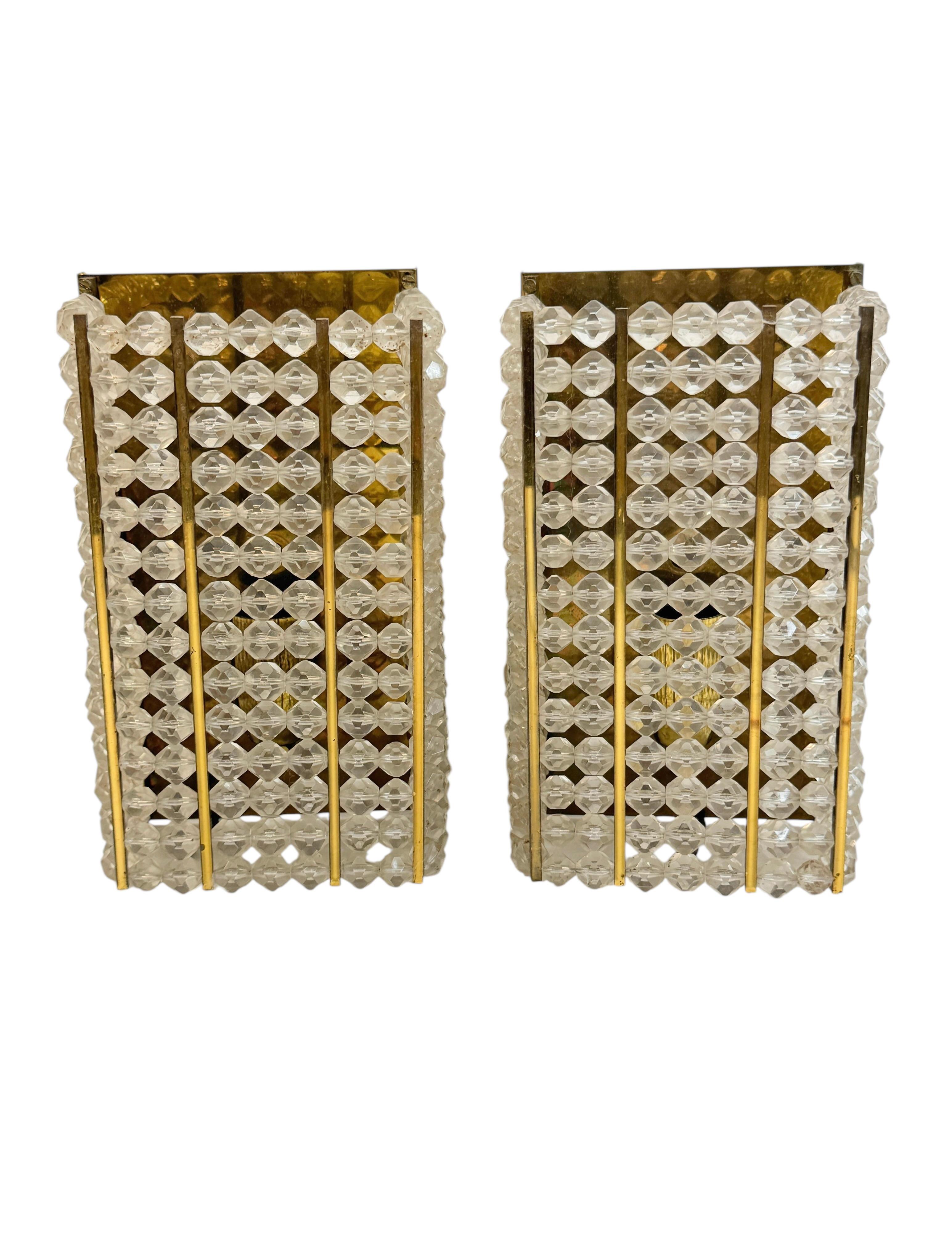Incredible pair of mid century modern wall sconces with brass metal plate and brass screws. This wonderful pieces were designed in Austria by Emil Stejnar during the 1950s. Made by Rupert Nikoll,
each sconce is outstanding as the way they are