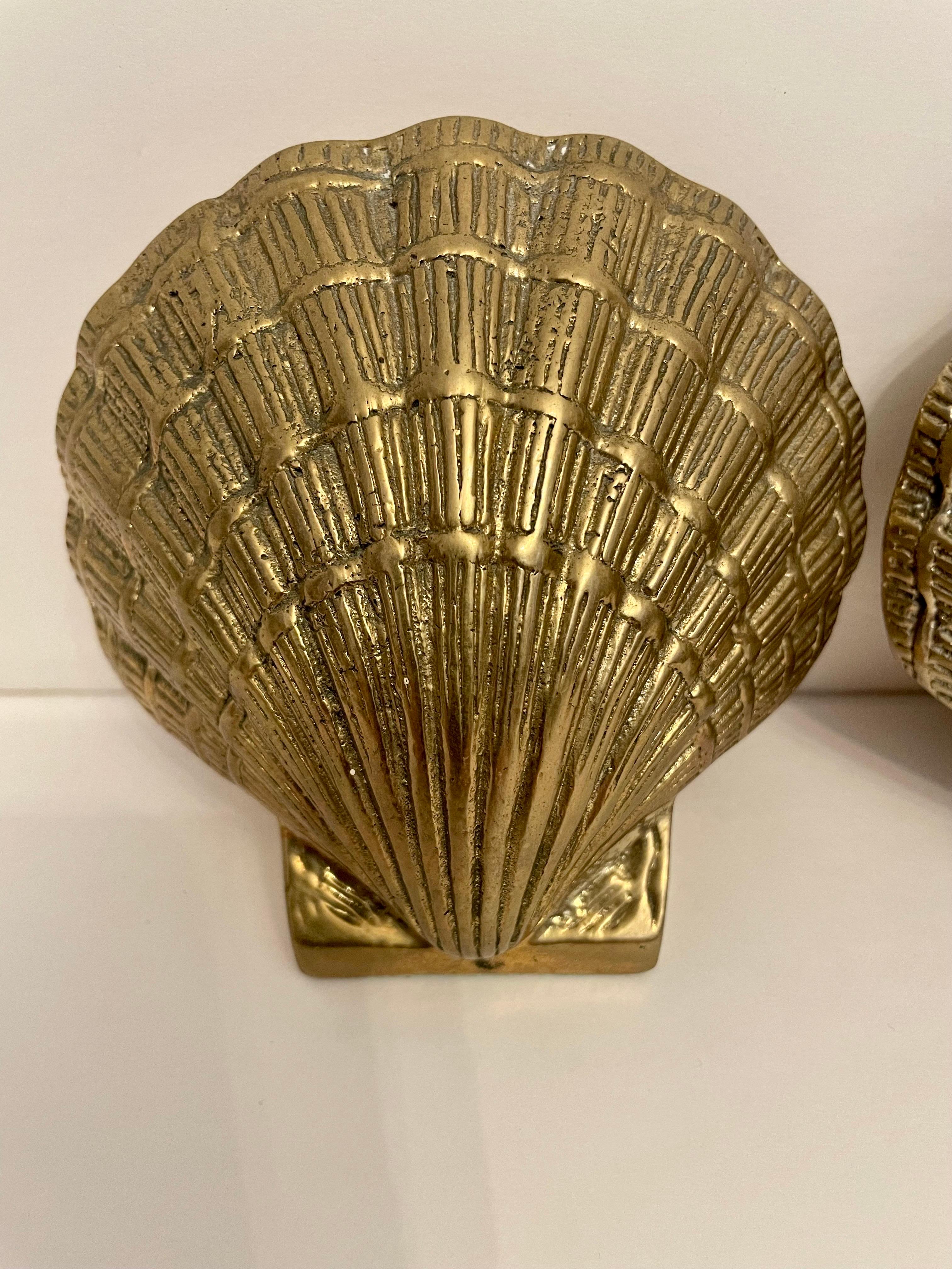 Pair brass clam shell or scallop seashell bookends. Nice condition. Ready to use. Slight patina from age and use. Good overall condition, hand polished.