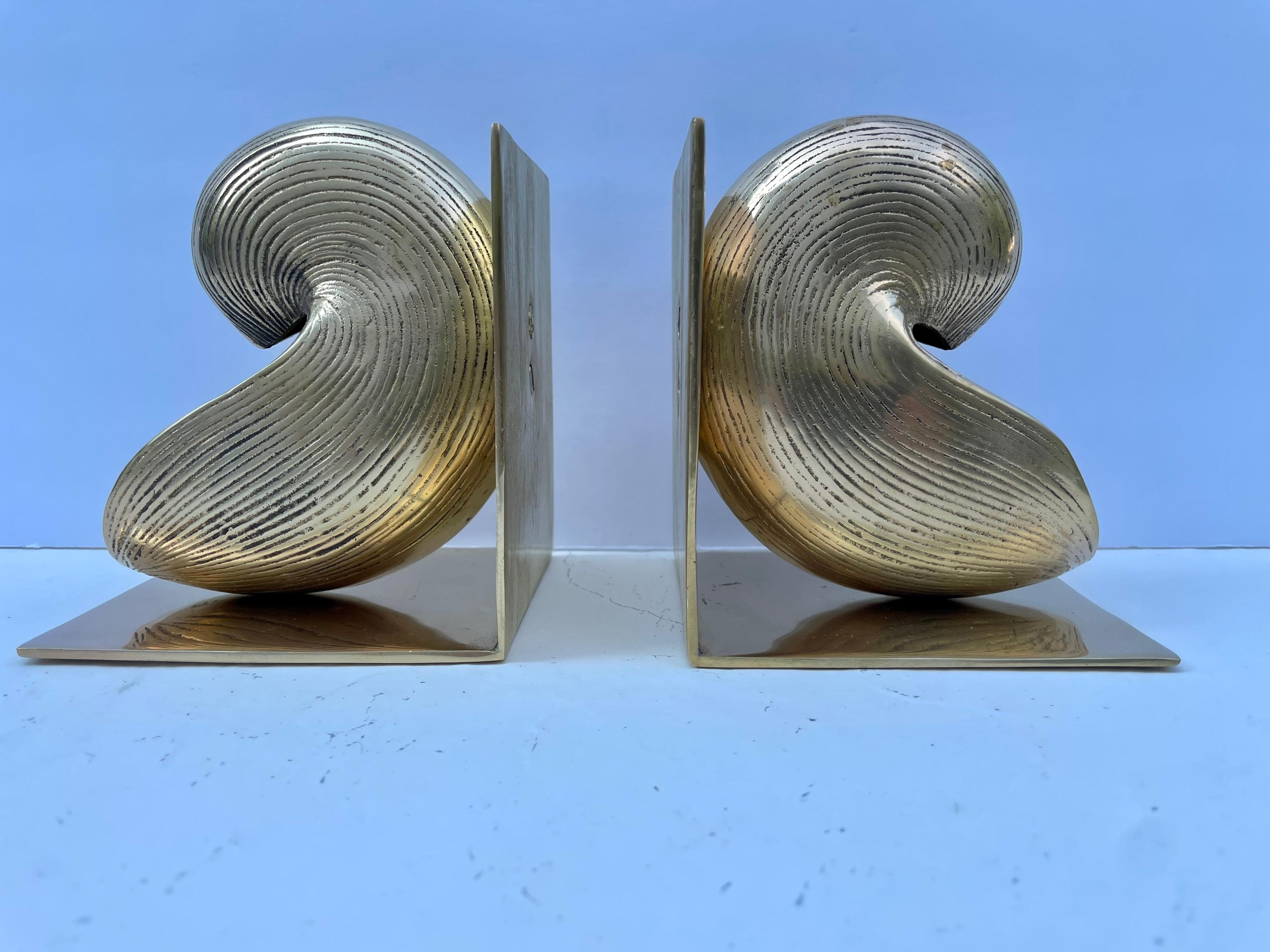 Brass nautical bookends. Nice detail in casting, heavy weight with substantial feel. Holds a shelves worth of books. Good condition, some light patina. Great for your beach house! 

Each bookend is 4.25 W x 5 H x 3.75 deep (8.5 wide overall).