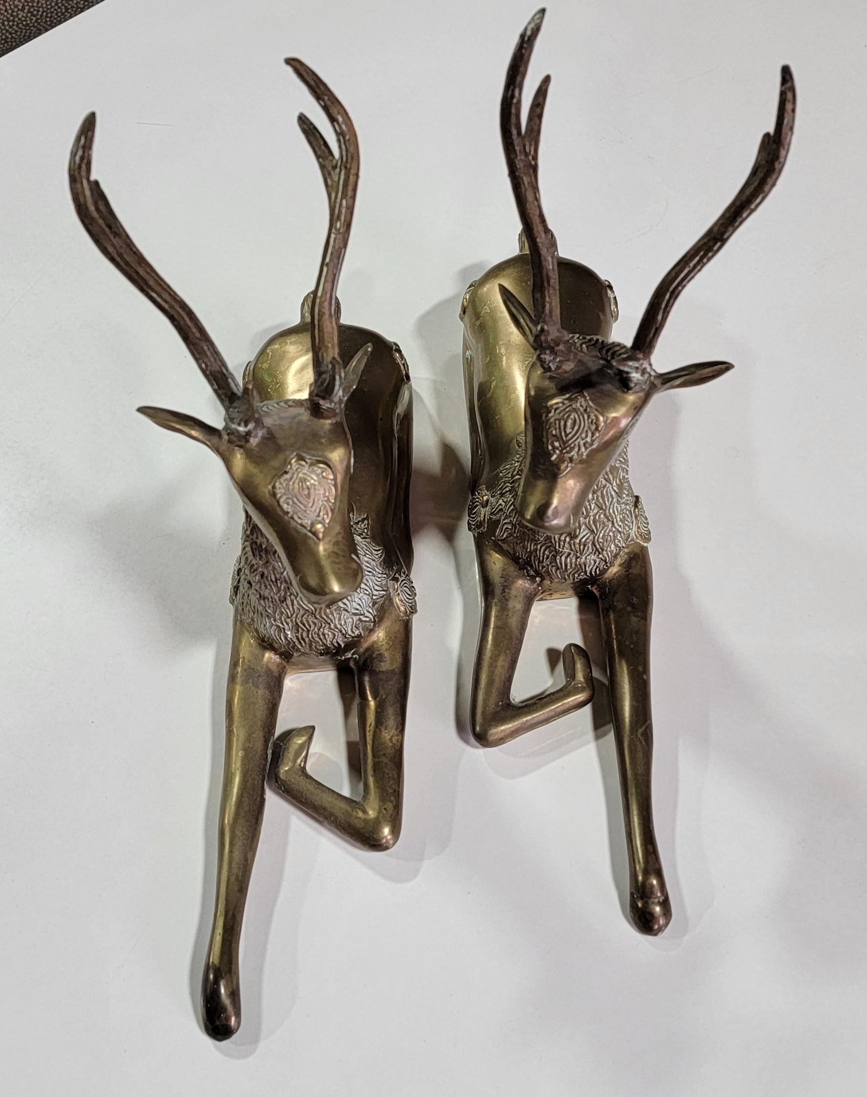 A pair of cast brass recumbent deer. Circa. 1970's.
