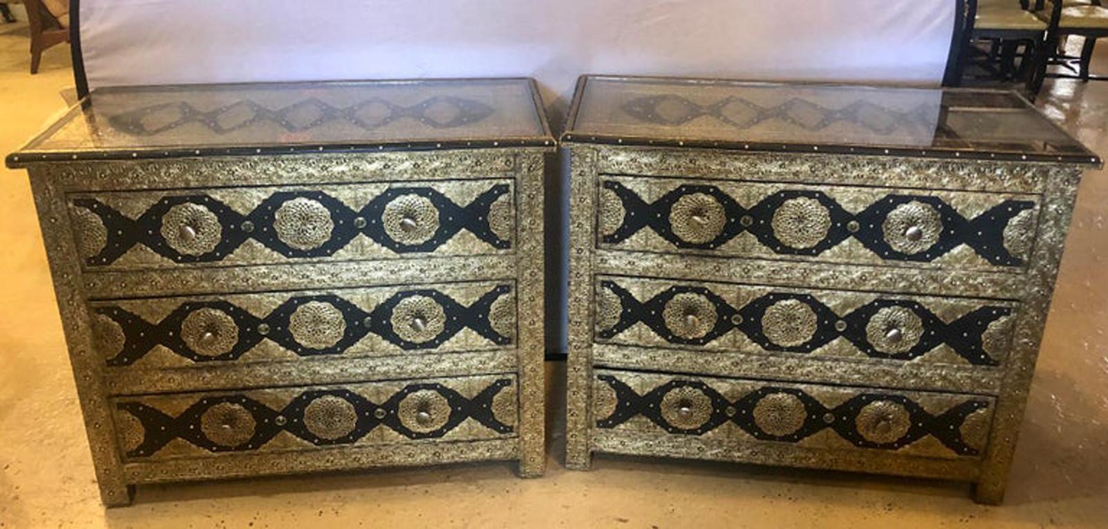 Pair of brass and ebony natural stone and leather inlaid Moroccan commode, chests or nightstands. These exceptional chests depict and compliment the Hollywood Regency era at its finest. Each featuring amazing intricate latticework on silver-toned