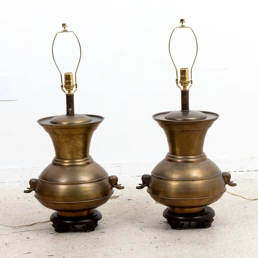 circa 1960s-1980's Pair of rewired brass  lamps on wood bases in the Hollywood Regency style.  Shades not included. Please note of wear consistent with age with a few spots of light patina. Good overall condition, ready to use.

